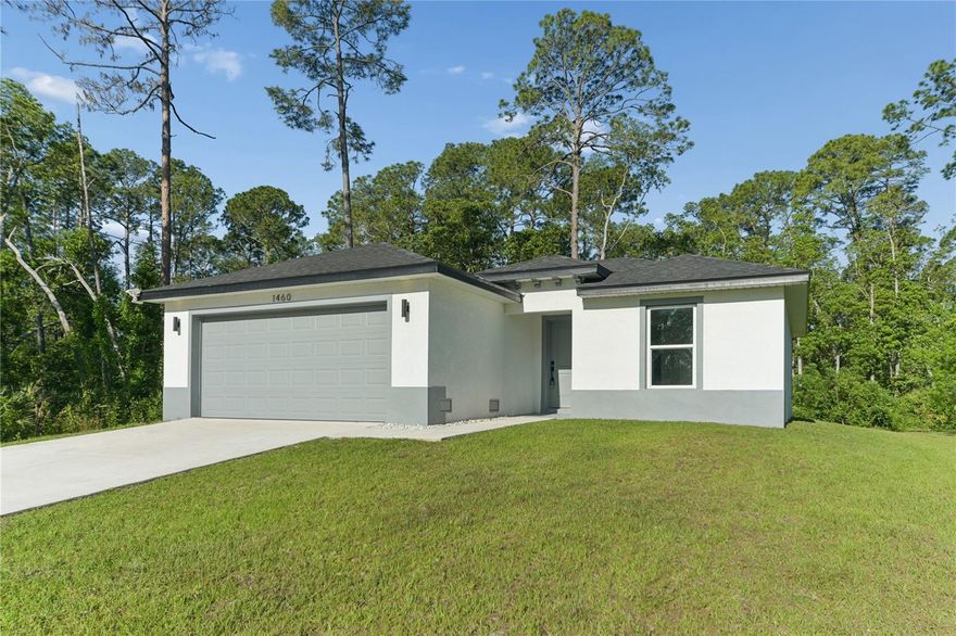This nearly new 2025-built, three-bedroom, two-bath home offers a perfect blend of peaceful living and everyday comfort. The open floor plan features quartz countertops, white cabinetry with black hardware and fixtures, stainless steel appliances, and luxury vinyl plank flooring throughout. The primary suite includes a walk-in shower and dual sinks. Additional highlights include epoxy-coated garage flooring. Enjoy the outdoors in the spacious yard, with plenty of room to relax and take in the natural surroundings. With no HOA, there’s ample space to park your RV or boat right in the driveway. Plus, with no water bill and low electricity costs, this home is both efficient and affordable. Despite its private setting, it’s just minutes from shopping, dining, schools, major highways, and DeLand Municipal Airport.