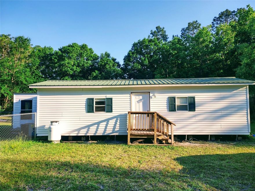 Over 1300sf of outbuildings in addition to main house! Enclosed porch could easily be converted to a third bedroom. 

Wild turkeys, blueberry bushes and grape vines on site! 

Tucked away in the heart of Osceola Forest, this renovated 2-bedroom, 2-bath home has peaceful rural living on 1.66 acres with guest house, massive garage, and storage shed. 

Surrounded by natural beauty, this property is great for those seeking privacy, quiet, and a connection to the outdoors.
