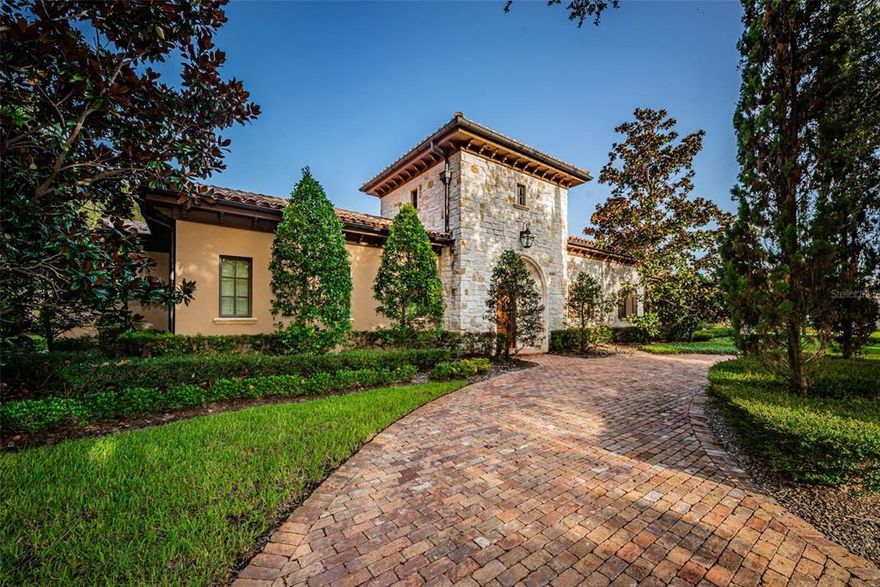 EXUDING THE LUXURY & GRACE OF A PEERLESS TUSCAN ESTATE WHILE OFFERING THE INTIMACY OF A TIMELESS HACIENDA VILLA, THIS VISUALLY-STUNNING ARCHITECTURAL MASTERPIECE IS ONE OF THE MOST UNIQUELY BEAUTIFUL HOMES IN FLORIDA!  Built by the owner of nationally-awarded and highly-acclaimed Windstar Homes for his own personal use, this brilliantly conceived residence demonstrates a level of thought and precision rarely found in homes at five times this price!  Depth, perspective and accuracy – from the smallest of details to the largest of engineering complexities - are implemented on a grand scale and give this home an orderly richness that is as uncommon as it is beautiful.  The soaring 20ft-high entry vestibule/tower opens to a spectacular “O” shaped courtyard surrounded by luxurious covered walkways connecting all areas of the home - centered by a magnificent pool/spa and fabulous living area with media center/fireplace.  Step into the 21ft-high “Great Hall” and take in dramatic stone & beam finishes - splendid living area with cast stone fireplace/hidden media center transitions to a sumptuous gourmet kitchen with the finest Busby cabinetry, superb granite surfaces, Subzero/Wolf appliances, gas cooking, island bar and island prep-center.  Dedicated wine room contains full-height Subzero wine chillers & bar. Through hidden doors, the kitchen opens to an opulent, multi-purpose crafts/study room, and separately, to a plush, sound-proofed, multi-video media/music center.  Looking for a private “zen-like” outdoor ambiance?  Your cloistered outdoor dining area enjoys the tranquil sounds of free-falling water. The owner’s suite is a picture of ingenuity & creativity, with fine seamless built-ins, multi-media entertainment, gas fireplace, cosmetics center, lush sitting area and huge walk-in closet with astonishing built-in closet system. Step into an owner’s bath that redefines luxury living.  Striking minimalist cabinetry is complemented by lavish fixtures, dual his & her vanities, dual water-closets and built-in jetted spa tub – everything perfectly chosen and ideally placed.  The walk-in shower boasts a separate steam room & a multi-head rain shower - exquisitely detailed in marble.  All bedrooms are oversized and all baths, meticulously appointed.  Separate guest suite, private basketball court, whole house automation and features/amenities far too numerous to mention here.  This level of elegance and precision-quality rarely comes to market.  Simply unforgettable!