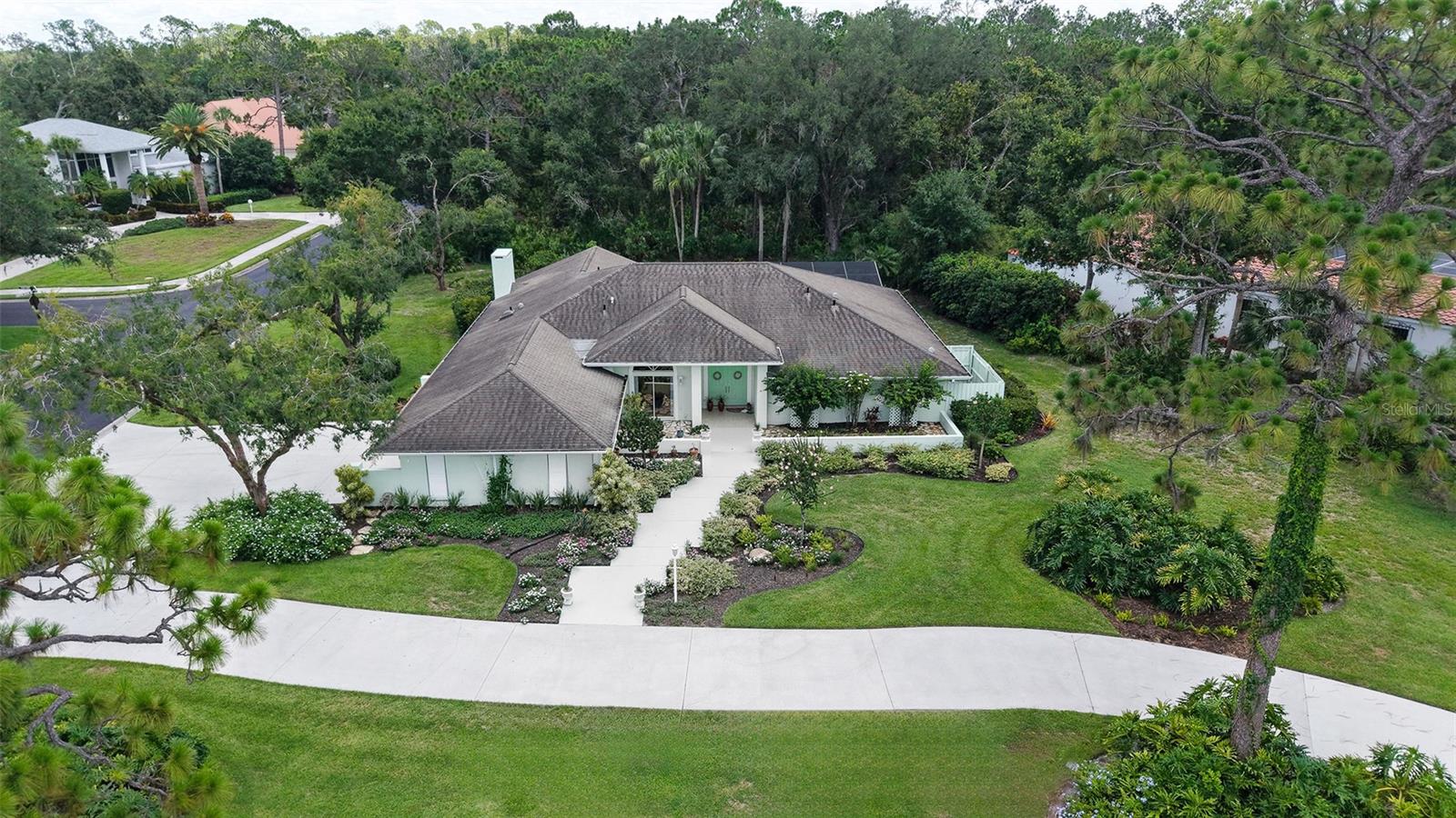 Discover this beautifully maintained three bedroom two and one half bath pool home, thoughtfully updated to provide comfort, efficiency, and contemporary style in a natural setting. The large kitchen has been updated with a new stove, refrigerator, dishwasher, disposal, and reverse osmosis drinking water equipment. A whole house water conditioner also ensures pristine water quality. Stylish luxury vinyl plank flooring has been installed in the living room, all three bedrooms, the great room, and kitchen. New ceiling fans have also been installed throughout the interior and lanai. The pool features a new pool sweep, and the entire pool cage frame has been freshly painted along with new screening installed in 2020. Fresh paint inside and out enhances every space with a clean, light, and bright look with abundant natural light provided by skylights throughout. The updates were more than just skin deep; Recent enhancements include a reinforced roof structure with the addition of “third nail” and enhanced roof straps providing peace of mind and lowered insurance costs. Other improvements include a new washing machine, water heater (2021) and a new well pump for irrigation. The professionally designed and well maintained landscaping is amazing to behold and offers outstanding curb appeal in both the front and back yards.
For those who love outdoor living, this home offers a sublime natural experience featuring a meticulously maintained butterfly garden including an elegant pergola just outside the family room’s sliding doors providing a serene and tranquil setting rarely found in even the most rural settings allowing you to watch the birds, butterflies and even the occasional deer cavort from the comfort of your family room. This property combines thoughtful upgrades, and inviting living spaces both inside and out—ready for you to move in and enjoy. Schedule your tour today to experience this exceptional opportunity firsthand!