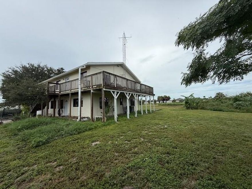 RARE OPPORTUNITY to own 4.7 acres in Sarasota County!  This property is a dream come true if you are looking for privacy, serenity, and upside potential.  NO HOA OR DEED RESTRICTIONS.  The property features a custom 3,000 sq ft garage and workspace with 3 oversized doors.  This garage / workshop space can’t be found anywhere else – lots of room for car enthusiasts, work trucks and vans, large equipment, RVs, campers and boats and anything else a workman, hobby-lover, business owner, boater, or outdoorsman would ever want or need.  And with the privacy and location the property offers, this opportunity can’t be matched.  This large garage space also features a bathroom and laundry area and it has full electric power and water.  The nearly 5 acres is mostly wooded with a large, private driveway at the end of the main street.  However, there are ample manicured grounds surrounding the main dwelling; perfect for cookouts and entertainment.  The main house is divided into two living units with separate entrances – an upstairs and a downstairs.  The home is quaint and has a ton of potential and features real oak wood flooring in the living area.  You could live in one area and rent out the other if you choose.  Lots of grounds space for parking, play and pets.  The location is also a dream – privacy and acreage in Sarasota County with public utilities but just a 2-5 miles away you are stepping foot on Manasota Beach, Blind Pass Beach and Englewood Beach!  The beaches have restrooms, showers, picnic areas and amazing sunsets! You also are near stores, restaurants and everything else you would want.  It is the perfect property featuring country living near all modern conveniences.  Private showings only.  Call us to schedule your time today.