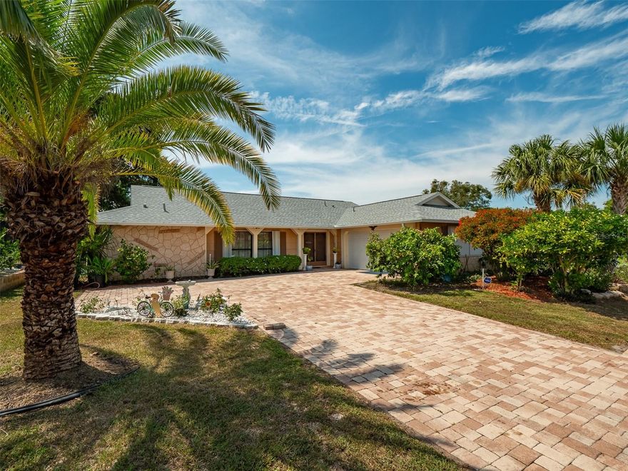 Huge price drop, ready to sell! Nestled in the heart of Ravenswood Village, is the ideal home for those seeking the perfect blend of location and Florida living. Situated on a spacious corner lot, this property boasts 3 bedrooms, 2 bathrooms, and a 2-car garage. The true gem of this home is the large screen enclosed pool, offering a private oasis right at your doorstep. Step inside, and you'll be greeted by the timeless charm of updated floors, adding character and warmth to your living spaces. The well-appointed kitchen features granite countertops, creating a culinary haven for both the gourmet and the everyday chef. Recent upgrades ensure your comfort and peace of mind. With a new roof in 2021, a modern HVAC system installed in 2022, and the pool screen and liner refreshed in 2021, you can enjoy your pool without a care. Additionally, a new pool filter and pump in 2022, a modern garage door from 2021, a water softener and purifier from 2021, and new irrigation sprinkler heads in 2022 add convenience and efficiency to your daily life. With the Hudson Beach Marina just 7 minutes away, your new home offers endless opportunities for leisure, water sports, and relaxation. Don't miss out on this extraordinary property. Call now to secure your dream home in Ravenswood Village today. Experience this beautiful home where convenient living, meets the lifestyle you desire.