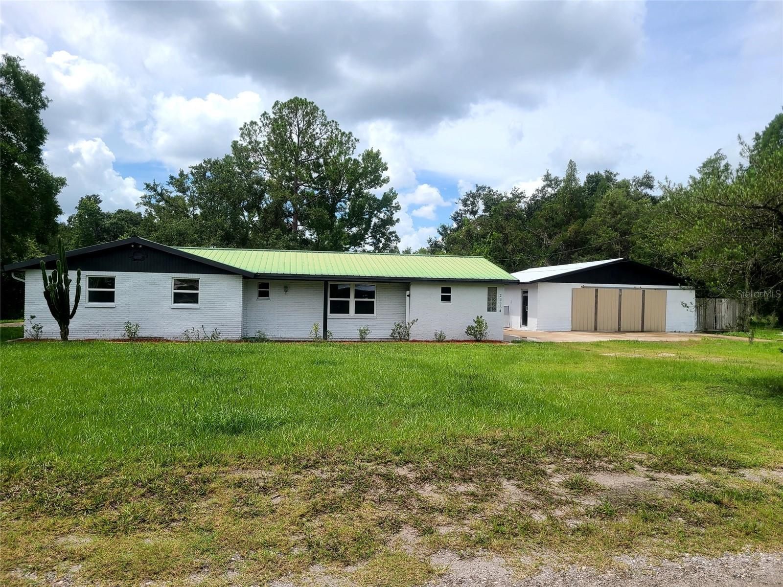 LAND O'LAKES COUNTRY SETTING POOL HOME ON 1 ACRE WITH A 6 CAR DETACHED GARAGE. Zoned AR. Horse Stables accross the street. This house is unique and has so much to Give. Metal Roof on Main House and a New Metal Roof on the 6 Car Detached Garage (Over 1080 sqft garage). Never Need a Roof again. No HOA. Have a Huge Pool Party on the Huge 45' X 80' Stone Paver Patio, of which, 35' x 45' has an Aluminum Cathedral Covering. All wired and ready for a TV. And Hot and Cold water supply lines are ready for a Bar and a Shower in 2 seperate locations. 2 Huge, 84" Outdoor Ceiling Fans with Remotes and Party Lighting all there. Many Parties have been Shared at this Location. The Pool is only 3 yrs old. Newer Marcite, Newer Pool Pump. Entering the Home You'll notice the Breaze-way between the home and the Detached Garage. Once inside the Large/Romy Kitchen has Newer Stainless Steel Appliance and the Laundry room is located here. The Family Room/Great Room is spacious and has Custom Double Wood Slider that access the Huge Cathedral Cover Patio. The Hall Bath was Remodeled 2 yrs ago with a New Tub & Shower, New Vanity and Custome Tiled Walls. All the Bedroom are super large. (Not the Cookie Cutter Style) The Primary Bedrm is 17' x 15' and has a Large Walk-In Closet. The Primary Bath has a Roman Style Tiled Arch Shower. The Vanity is a 1 piece, Corian Vanity with additional space for a Make-Up Counter. NOW the outside. The Property even has an RV Hook-Up Electric and a Mini-Septic. For that person who loves a Huge Garage/Workshop to keep their toys or to tinker or Run a Small Business. The Garage is in Good Functioning Shape. SELLER SEZ: "GIVE THEM A NEW A/C" Seller will provide a New A/C with an Acceptable Deal. This Home is USDA Eligible. (No Down Payment Needed) Get the State of Fl. Bond Money (Gives Buyer's $10,000) Come see. Alot of Home for the Money, Ready for a New Owner! Vacant. Call Ron to see or get Info about these Loan Programs