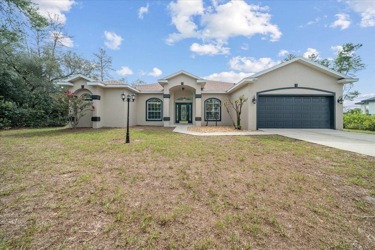 Welcome to this stunning and spacious 3-bedroom, 2-bath home in the desirable Southwest neighborhood of Ocala Waterway, where comfort and style meet practical living. This home is designed for a modern lifestyle with a highly sought-after split-bedroom floor plan, ensuring privacy for the master suite. Step inside and be greeted by a bright and airy living space, enhanced by high ceilings that create an open and expansive feel. The heart of the home features a huge kitchen with ample counter and cabinet space, perfect for the home chef and for entertaining guests. The versatile layout includes both a formal living room and a cozy family room, centered around a charming fireplace—ideal for relaxing evenings or holiday gatherings. Recent updates provide peace of mind and modern appeal, including a new roof in 2021 and a new hot water heater in 2024. The home’s interior and exterior have thoughtful architectural details that elevate this home's design. Graceful arches, elegant columns, and stunning tray ceilings define the space, adding a touch of sophistication and character to every room. The home was freshly painted inside and outside giving it a pristine, move-in-ready finish. Venture outside to a rare private, treed lot that offers a serene and secluded setting. The fully fenced-in backyard is perfect for pets and family activities. A unique and valuable feature is the dedicated outdoor half-bath, already in place and plumbed, ready for you to add a future pool and create the ultimate outdoor oasis. This home is more than just a place to live; it's a foundation for a comfortable and convenient lifestyle in a fantastic Ocala location. Don't miss your chance to own this meticulously maintained and thoughtfully updated property.
