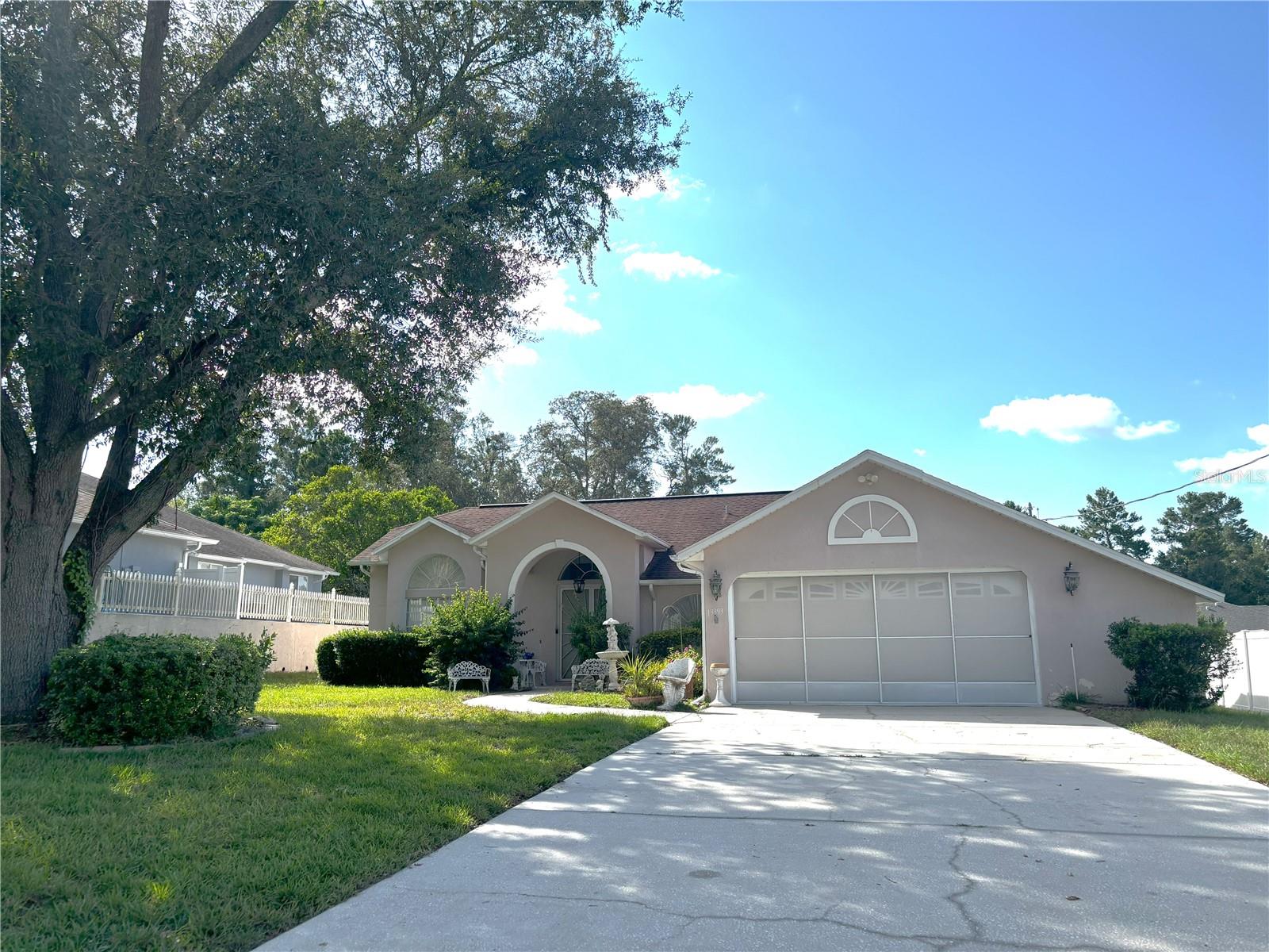 Welcome to this beautifully maintained 3-bedroom, 2-bathroom home offering 1,779 sq. ft. of comfortable living space and a total of 2,549 sq. ft. under roof. Built in 1993, this residence features a desirable split and open floor plan, perfect for both entertaining and everyday living.
The master suite boasts his-and-hers closets, a relaxing garden tub, and a separate walk-in shower. The heart of the home includes a spacious kitchen with newer stainless steel appliances and an adjoining dining area. An enclosed, air-conditioned lanai extends your living space and offers relaxing views of the expansive, fully fenced backyard — perfect for gatherings, gardening, or adding a pool.
A generous 2-car garage provides ample parking and storage, while major updates including a roof and AC replacement in 2012 offer peace of mind with more than 10 years of expected life remaining — a valuable plus for insurance savings.
Situated in a quiet neighborhood with no HOA, this home offers both privacy and convenience, with plenty of yard space for friends and family, pets, or future outdoor projects.
Note: All items pictured will be removed during an estate sale scheduled for the end of August, allowing you to move in and make the space entirely your own.
This home truly combines comfort, functionality, and potential — a rare find you won’t want to miss!