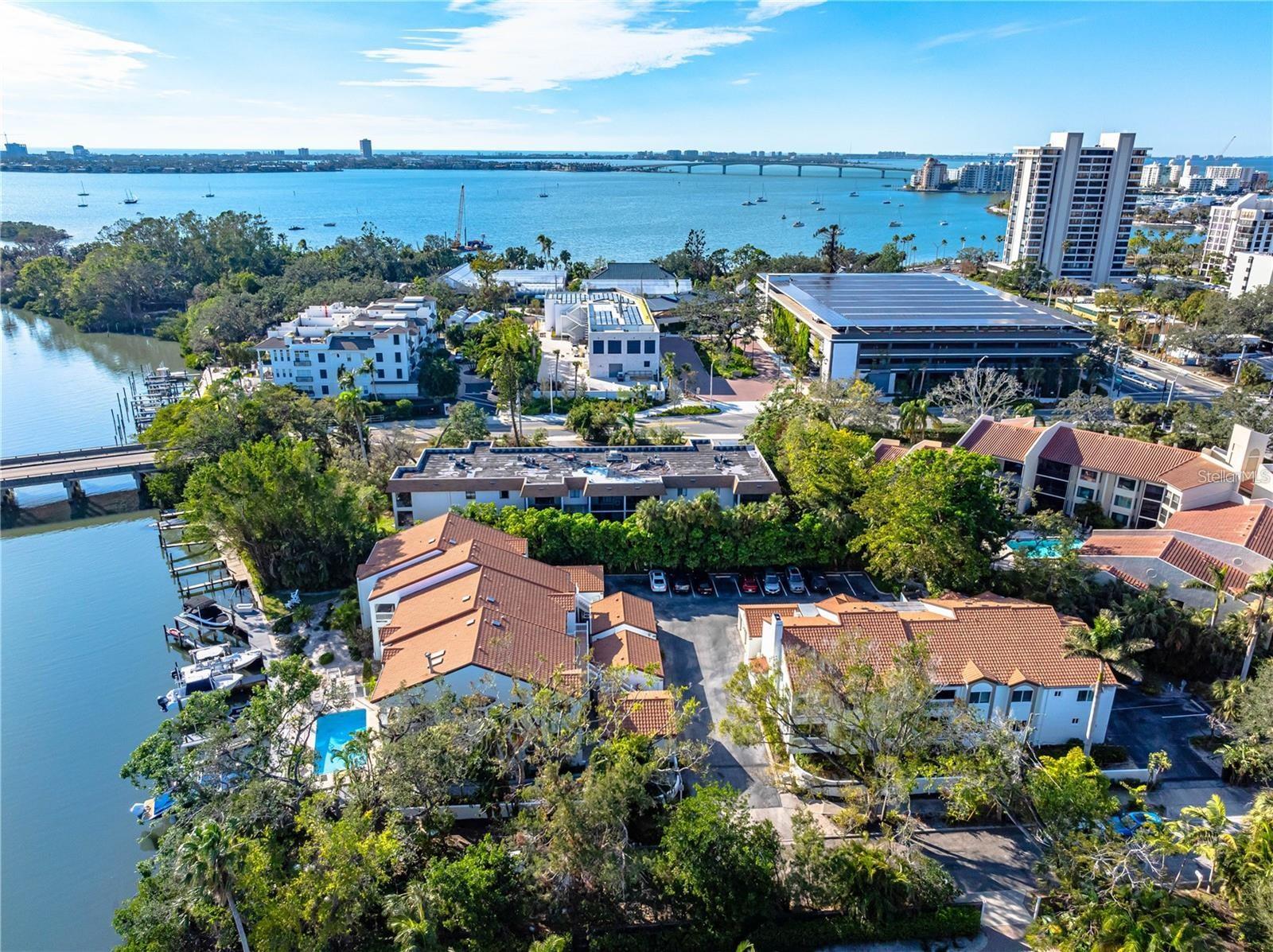 Live the Downtown Waterfront Lifestyle – Deeded Dock Included!
Brand new exterior paint! This beautifully renovated 2-bed, 2-bath condo with a den (optional 3rd bedroom) is a rare find in Sarasota’s desirable West of the Trail neighborhood. Located in Hudson Landings, a quiet 12-residence community just minutes from downtown and the bay, this light-filled second-floor corner unit offers modern updates and an unbeatable lifestyle. The list price includes a deeded dock and a 10,000-lb boat lift—brand new with updated pilings and cradle—providing quick, direct access to Sarasota Bay and the Gulf of Mexico. Bring your boat and enjoy the ultimate Florida living experience!
Inside, you'll find a vaulted exposed-beam ceilings and abundant natural light with a sleek contemporary kitchen with custom cabinetry, newer granite countertops, glass tile backsplash, and top-of-the-line stainless steel appliances, including a built-in double oven and glass cooktop, and a spacious Italian-style shower in the updated bathrooms. Plus a cozy wood-burning fireplace for cool evenings and an enclosed patio with large hurricane-rated sliding windows, creating a bright and inviting dining area
Step outside and you’re just a short walk to Marie Selby Botanical Gardens, the Sarasota Bayfront, and vibrant downtown Sarasota. This peaceful community also features a heated pool, lush landscaping, and a truly secluded atmosphere—no damage from recent storms Helene or Milton; docks and boats remained intact.