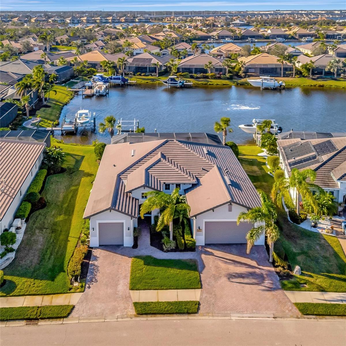One or more photo(s) has been virtually staged. Welcome to Tidewater Preserve, Bradenton's premier boating community! Nestled along the scenic Manatee River, this stunning Boretto Model offers breathtaking waterfront views in a private, resort-style, gated community. This upgraded 3-bedroom + den, 3-bath home with a 3-car garage boasts a spacious open floor plan designed for both comfort and functionality. The heart of this home is the chef’s kitchen, featuring wood cabinetry and quartz countertops, a large island with bar seating, stainless steel appliances, including a new Samsung refrigerator (2023) and new dishwasher (2024), a touchless kitchen faucet for added convenience, an LED ceiling fan in the living room, and a walk-in pantry with custom wood shelving. The primary suite offers maximum privacy and includes a luxurious bath with a walk-in shower, soaking tub, dual sinks, and expansive his-and-her walk-in closets. On the opposite side of the home, you'll find two guest bedrooms and 2 baths for maximum separation and comfort. Additionally, a large office/den provides the perfect space for a home office or flex room. This waterfront home is set on a 110-foot lot, featuring a 12,000 lb boat lift and a finished Trex dock for durability and low maintenance. The outdoor oasis includes an oversized resort-style 6-foot pool with a spa, highlighted by LED lighting, a breathtaking waterfall with a fire wall feature, a new rapid heater, and a no-see-um screen enclosure for year-round comfort. The fully-equipped outdoor kitchen includes a grill, refrigerator, sink, and wine fridge. The gas firepit area, complete with a cozy couch and two chairs, creates the perfect gathering spot. For added convenience, there is a dedicated pool bath, as well as a remote-controlled awning and privacy screens to enhance comfort. This home is packed with luxury upgrades, including a whole-house Kinetico water softening system, Smart Thermostat, Ring doorbell, tankless water heater, custom closets throughout, renovated bathrooms with frameless glass showers, a premium surround sound system inside and out and extended driveways in 2022. Recent updates in 2024 include freshly painted interior and exterior, roof cleaned and sealed, and HVAC system & ductwork serviced. This home combines luxury finishes, smart home technology, and waterfront living for the ultimate Florida lifestyle. Don’t miss the opportunity to make this dream home yours! For boating enthusiasts, the community boat lift provides easy access to the Manatee River, allowing you to arrive at your favorite waterfront restaurant in style or embark on a scenic adventure to Anna Maria Island or Egmont Key. Located in the gated boating community of Tidewater Preserve, this home offers 24-hour guard security for peace of mind. Residents enjoy top-tier amenities, including a 3 resort-style pool, clubhouse, 2 fitness center, tennis courts, riverfront nature trails, dog park, playground, kayak launch, and marina. Best of all—No CDD fees! End each day with breathtaking sunsets from your private dock, embracing the ultimate waterfront lifestyle. An exceptional home in a premier waterfront community—don’t miss your opportunity to make it yours!