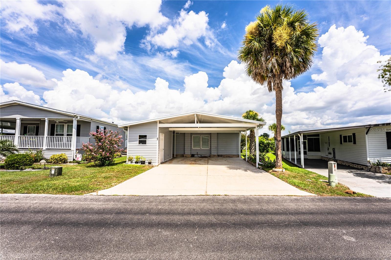 Enjoy Florida living at its finest in this beautifully updated and furnished 2-bedroom, 2-bath lakefront home in the sought-after 55+ community of Floral Lakes. Step inside to a bright, contemporary space featuring a modern kitchen with a solid surface countertop and bar and stunning lake views of Flora Lake, the largest lake in the Floral Lakes community!
The open living and dining area boasts custom built-ins and windows for plenty of natural light. The private primary suite offers a walk-in closet and an updated bath with a walk-in shower and its own linen closet. The guest bedroom could also be a spacious home office. The secondary guest bath is also updated with storage galore!
Entertaining is effortless with an all seasons lanai, blending indoor comfort with outdoor freedom. Glass windows may be opened for a screened porch feel or closed with the air conditioner unit keeping you cool! The open concrete patio, and beautiful landscaping makes for a peaceful place to relax while watching the wildlife on the lake! Additional highlights include a 2019 HVAC, vaulted ceilings, a new two-car carport and storage space that was built this year and meets hurricane codes, a 2022 moisture barrier and engineered flooring throughout!
Floral Lakes offers incredible amenities: clubhouse, fishing, boat
Ramp and dock, large heated pool, shuffleboard, recreation space, putting green, garden areas, and optional RV storage. If Social clubs, dances, and pot lucks are what you love…. You are definitely in the right location! Centrally located near shopping, dining, and a short drive to Tampa, Orlando, and Florida beaches. Association approval is required for purchase. Call your Realtor today to schedule your showing!
Schedule your private showing today!