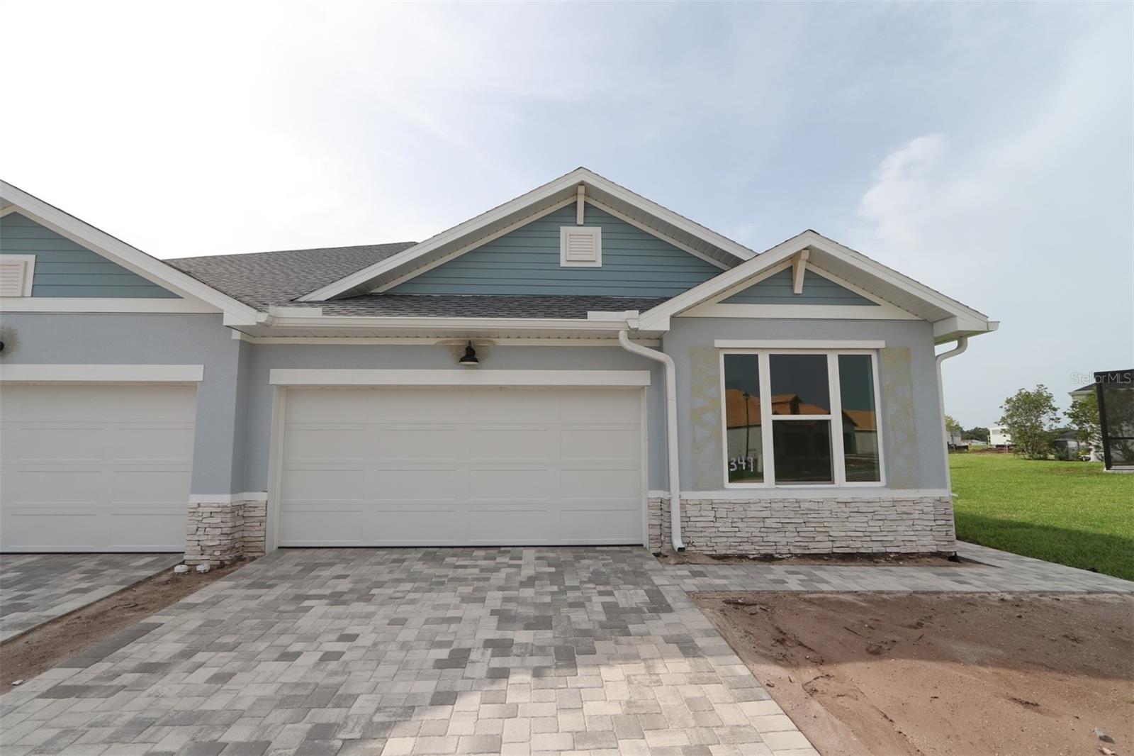 Under Construction. Built by David Weekley Homes, the Fieldview is a stunning example of craftsmanship, offering a refined blend of luxury and tranquility in the sought-after Gracewater community near downtown Sarasota. This elegantly designed single-story paired villa features 2 bedrooms, 2 bathrooms, and a 2-car garage, thoughtfully crafted for both comfort and convenience. Step into the enclosed study, a serene space perfect for productivity or quiet retreat. Unwind in the spacious owner’s suite, a private haven designed for relaxation. The heart of the home opens to a large lanai, where breathtaking views of the private amenities create a seamless connection between indoor elegance and outdoor serenity. The designer kitchen is a masterpiece of style and function, adorned with a natural, organic palette of soft earth tones and airy neutrals that evoke warmth and harmony. Designed for easy living, this home includes lawn maintenance for a low-maintenance lifestyle, while hurricane impact windows provide enhanced security and peace of mind. Experience the best of Sarasota living with the Fieldview—where sophistication meets effortless comfort.