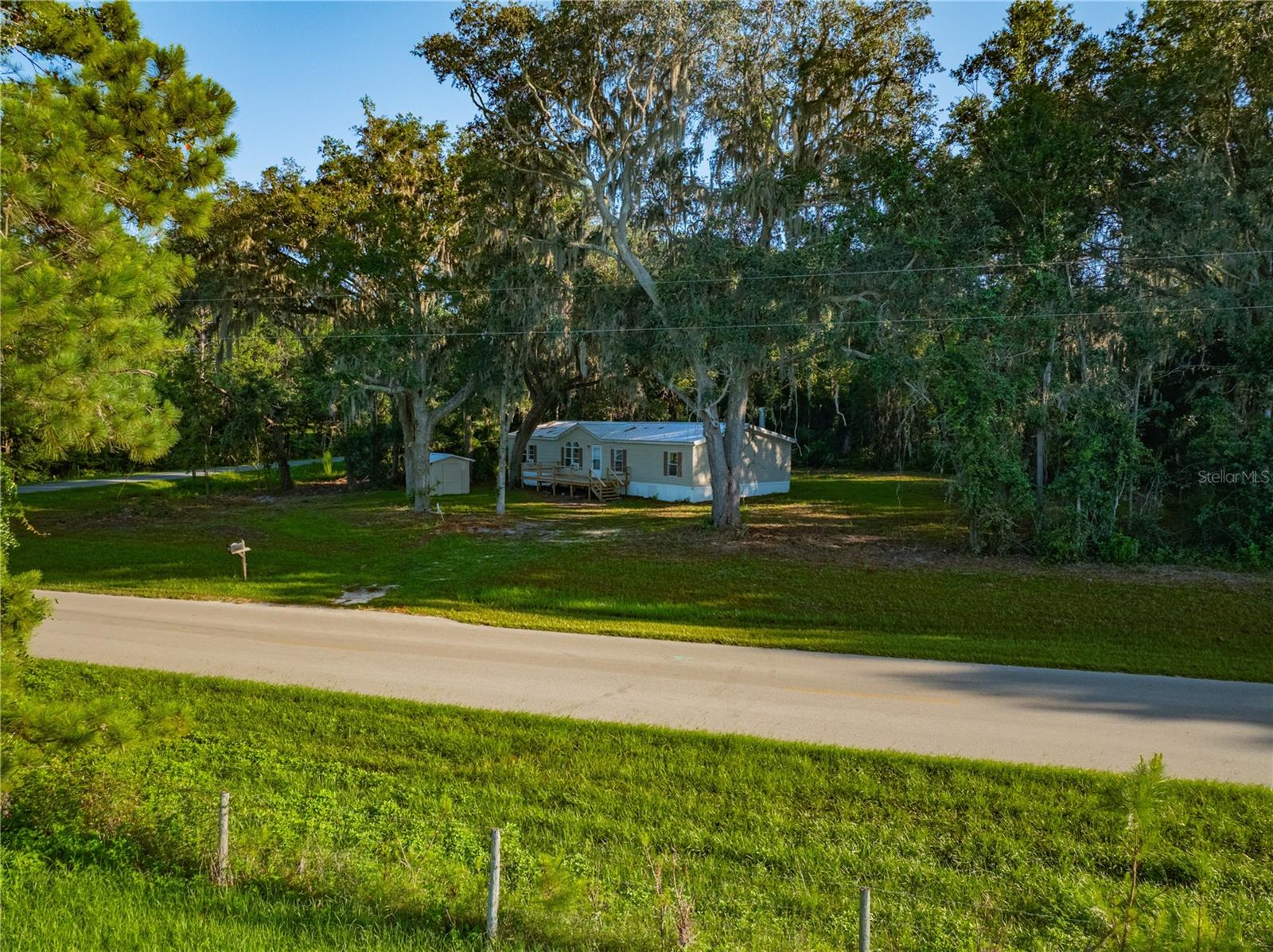 Beautiful location in the Providence community in Lake Butler, surrounded by gorgeous rolling ranch countryside. This 2 acre parcel has a 1998 doublewide mobile with a brand new kitchen complete with new cabinets, new counters, appliances, new flooring and carpets, freshly painted inside, and new front and rear decks Seller has made many recent improvements including new doors throughout. New well pump and pump house. Metal roof installed in 2024. Living room features a woodburning fireplace and built in shelves surrounding the fireplace. Primary bathroom has dual sink vanity and separate garden tub. Seller is amenable to seller financing with a substantial down payment. Although he will accept financed offers, Seller is selling As Is. The home has gorgeous views and a very private backyard. Roomy, with three bedrooms and two baths. Seller is pricing this to be affordable in a the beautiful neighborhood of Providence. Convenient to Gainesville. Come enjoy country living in a fantastic location!