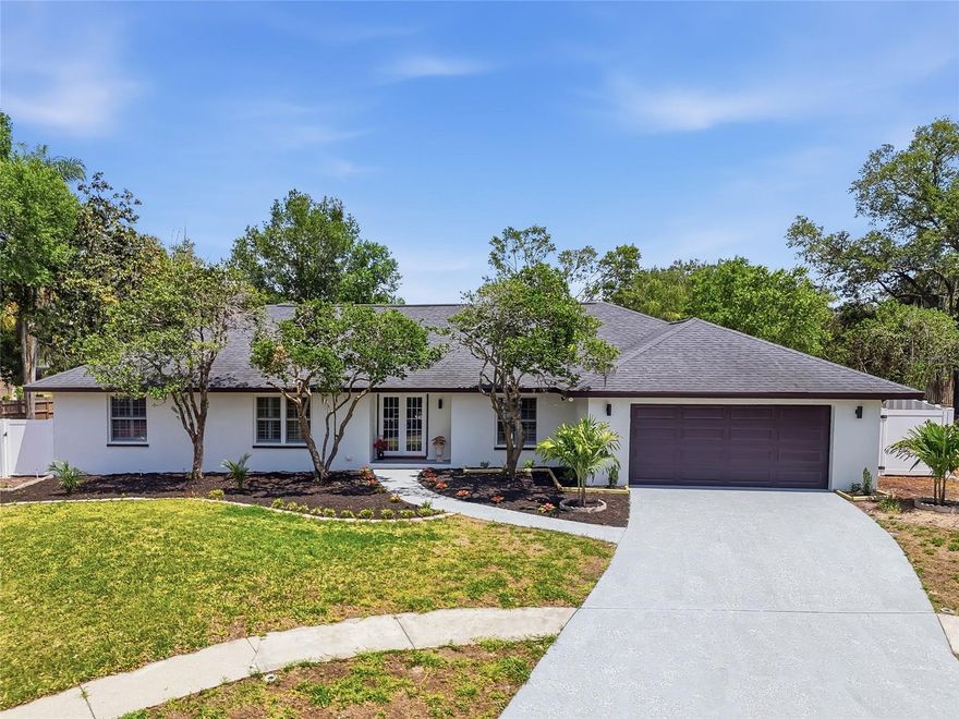 This 'rare gem' Valrico POOL home sits next to Buckhorn Gulf Club Estate has been beautifully updated and is located on a tree-lined, cul-de-sac street with 1 way in 1 way out and boasts charming curb appeal! This renovated home features cathedral ceilings with wood beams, a burning fireplace, and a private pool. This 4-bedroom, 3-bath, 2 living rooms, 2-car garage home sits in a NON-EVAC, NO Flood ZONE. Home blends classic Florida charm with thoughtful updates and modern smart home features, all set on a beautifully landscaped, oversized lot. Inside, you’re greeted by a formal living room, family room, dining spaces with views of the resurfaced pool (2026) and the fully fenced backyard (new in 2026) — perfect for entertaining. As you step inside the foyer, off to the left, you will find the separate formal living that are accented with oversized windows allowing natural light to filter in. Just past the foyer, you will find the open family room with stone front-wood burning fireplace, beautiful wood beams, vaulted ceiling, and double French doors leading to the lanai, which is large enough to entertain a sitting area, dining area, and still have room for a hot tub! The kitchen and family room combo is the heart of the home, featuring a cozy wood-burning fireplace, ample prep space, new appliances, and a sunny breakfast nook with sliders to the lanai. The family room floors were updated in 2026, bringing a fresh, modern tone. The private primary suite includes vaulted ceilings, dual walk-in closets, lanai access, a double sink, and a stand-alone shower. Three more spacious bedrooms are privately tucked away on the opposite side of the home, walk-in closets, as well as an additional bath with lanai access. Roof 2019. Updates/amenities include: New A/C HVAC, New Electric Panel, New windows, New Fence, Dry bar Area with wine fridge , Each bathroom confitures double sink vanity, New Washer & Dryer included inside the home separate room, Pool resurfaced  2026. Window treatments  new, Home has completed replumbing with permits and many more. No HOA fee, so bring your boat, trailers RV. Elementary, Middle and High school just 1 mile away. You wont be disappointed.