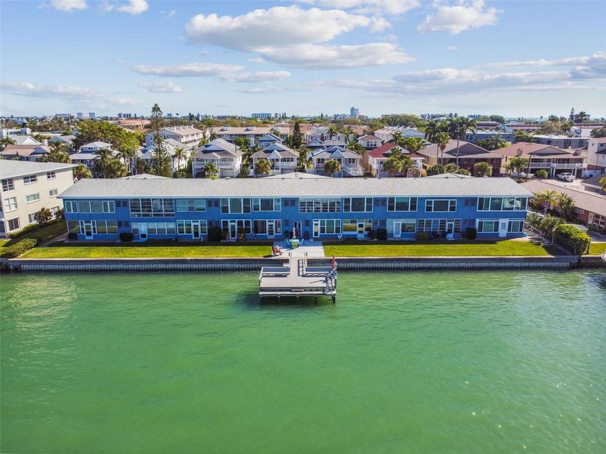 Discover your perfect retreat in this charming 1-bedroom, 1-bath condo, where every day feels like a vacation. Nestled in the serene Isle of Capri in Treasure Island, this delightful second-floor unit offers breathtaking views of boats gliding by, playful dolphins, and stunning water vistas across from John's Pass. Step into your air-conditioned Florida Room, where you can soak in the spectacular scenery year-round or let the gentle breeze flow through open windows. This cozy, light-filled condo is thoughtfully designed for both full-time living and an idyllic beach getaway. The kitchen, with its adjoining dining area, is bright and welcoming—perfect for enjoying your morning coffee while planning your day. The spacious living room is bathed in natural light, creating a warm and inviting atmosphere for relaxation or entertaining. This well-maintained 55+ community boasts a new roof (2017) and a freshly paved parking lot. You'll also appreciate the convenience of a private storage space downstairs for your beach gear and a laundry area for added ease. Take a leisurely stroll to the beach or enjoy a peaceful walk through nearby Rosselli Park. As the day winds down, catch the sunset from the sandy shores or unwind with neighbors on the dock, under the shade of an umbrella, or in the comfort of your cool Florida Room. With only 20 units, this quiet, pet-friendly community offers a tranquil lifestyle just minutes from two international airports. Don't miss your chance to own this slice of paradise—schedule your showing today and start living the beach life you've always dreamed of. Financing options are available. Land lease through 2066.