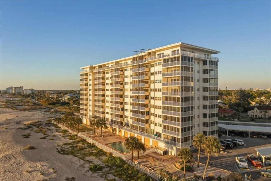 There are condos on Venice Beach. And then there is this one. Unit 301 at Venice Sands is a rare, true end unit offering something that simply cannot be replicated: a wraparound balcony with sweeping 180-degree Gulf of America views, direct beach access, and some of the most spectacular sunsets on Florida's Gulf Coast. If you have been searching for a beachfront home where every single day ends in a private front-row seat to nature's most extraordinary show, your search ends here. From the moment you step inside, it is clear this home has been thoughtfully updated with a modern, coastal aesthetic. New flooring flows throughout the entire unit, perfectly complementing the light-filled, open feel of the space. Crown molding adds a refined finishing touch throughout. The living room is oriented to capture the Gulf in a full panoramic scene, with oversized sliding glass doors that dissolve the boundary between inside and out. Step through and you are on the wraparound balcony, where the Gulf stretches as far as the eye can see in every direction. This is where mornings start, evenings end, and time simply slows down. The dining room is equally remarkable. Wrapped in floor-to-ceiling windows and slider access to a second private balcony, it captures layered views of the coastline, the Intracoastal, and the lush tropical landscape below. Every meal here comes with a view most people only experience on vacation. The primary bedroom suite is a true retreat. Bathed in natural light with direct Gulf views and its own window on the sea, it features a generous walk-in closet and a serene, well-appointed bath. The split floor plan ensures complete privacy for guests, with the second bedroom and bath tucked away on the opposite side of the unit. Venice Sands offers the full resort lifestyle: a beachfront pool, direct deeded beach access, and the ease of secure garage parking, a rare and valuable amenity at this address. The location places you steps from the sand and just minutes from charming downtown Venice, with its renowned dining, boutique shopping, the Venice Theatre, and the famous Venice Fishing Pier. End units of this caliber in a direct beachfront building on Venice Beach are extraordinarily rare. The combination of wraparound views, modern finishes, garage parking, and an unbeatable location at 633 Alhambra Road makes this one of the most compelling Gulf-front opportunities available on the Suncoast today. Venice Sands · Venice Beach · Sarasota County · Venice FL 34285