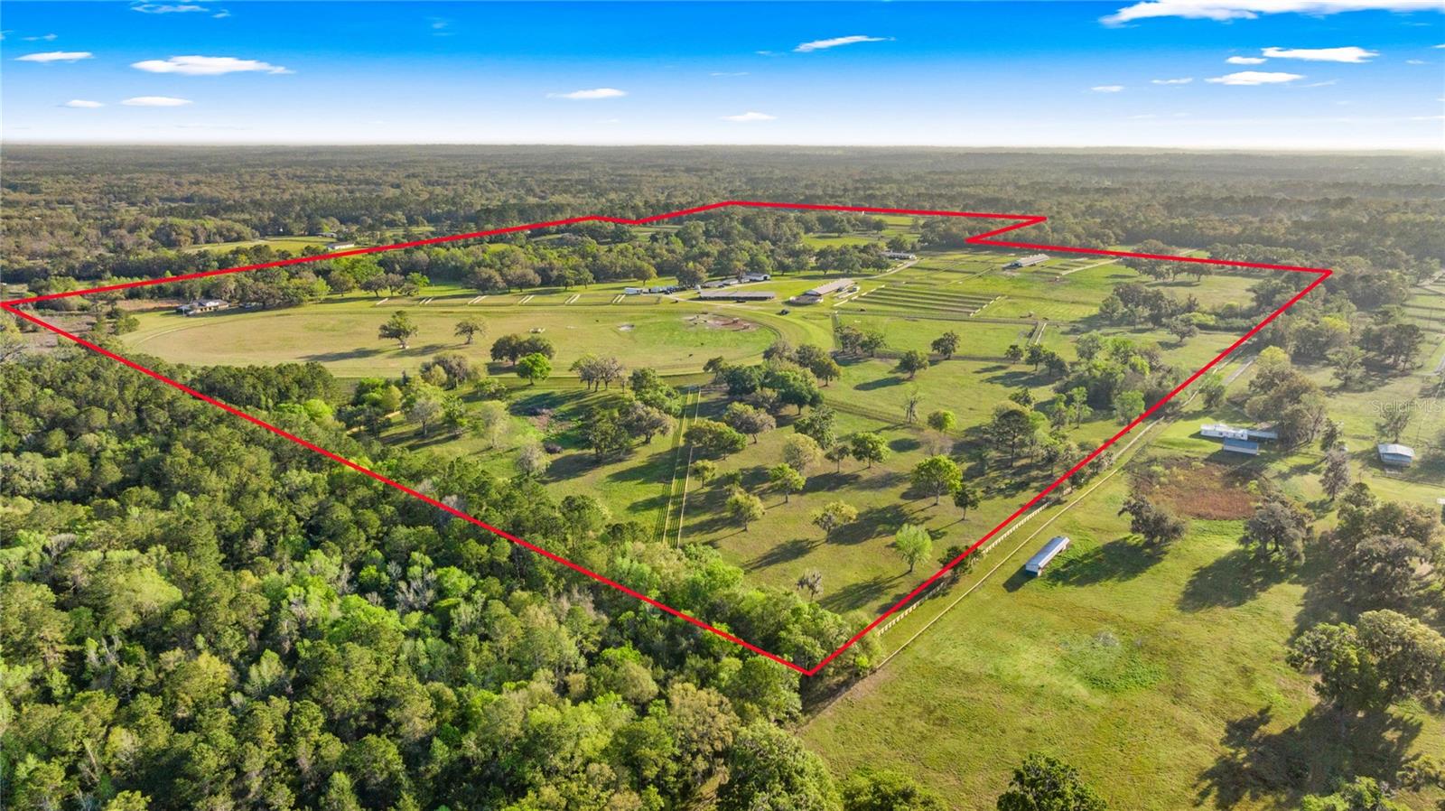 Under contract-accepting backup offers. Discover a sprawling 194-acre equestrian paradise, 4 miles to HITS and just under 10 miles to WEC. This impressive setup boasts seven barns with over 130 stalls, a 7 bedroom house, a 2 bedroom log cabin, a 2 bedroom house with a pool, a renovated 4 bedroom staff quarters and multiple other cozy barn apartments. Horses will thrive with 20 meticulously cross-board fenced paddocks, a speedy 5/8-mile track, a state-of-the-art horse walker, and a refreshing equine pool. The property also boasts brand new metal roofs on the barns as well as a large, irrigated sand jumping arena. Toss in 9 RV hookups, and you’ve got a versatile haven ready for trainers, riders, and dreamers alike. All Buyers should independently verify all information provided regarding this Property. The Sellers, Realtor and Broker make no representation as to the accuracy of this information. All Buyers should perform their own independent due diligence regarding this Property before executing a Contract for Sale and Purchase for this Property.