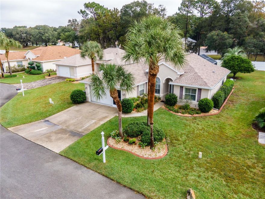 Beautiful pool home in Oak Run Country Club. Oak Run is a 55+ gated golf course community. This model home is a Great Room Doral. This is a 3 bedroom, 2 bath home with a 2 car garage. This home is on a maintained lot, so no grass to cut here. They also water it, fertilize & edge it and that is all included in your amenity fee. Lush landscaping so great curb appeal with 3 palm trees in your front yard. Inviting foyer that opens to your kitchen on your left with wood cabinets with crown molding, granite countertops and a pantry. Just off the kitchen is your inside laundry area. Your 2nd bedroom is a good size & has a large window so it is light & bright. The guest bathroom is just off the 2nd bedroom. The 3rd bedroom is currently being used as an office, but it does have 2 closets in it. The home opens up to a huge great room with 14' ceilings. So there is a very large chandelier over the dining room table. Laminate floors throughout & a large window overlooking your pool. There are sliding glass doors that open to your lanai area & pool. This is a great area to have a glass of wine at, it has curtains for privacy and over looks the salt pool. Just off your great room is your primary bedroom and walk-in closet. Your ensuite bathroom has just been updated and is a must see. New roof 2021. This truly is a beautiful home and would be a great place to retire to.  Amenities include 6 Community Pools (1 inside heated pool), Country Club, Fitness Center, Billiards Room, Ceramics Studio, Card Room, Library, Bocce Ball, Shuffleboard, Horseshoe Pits, Lit Tennis Courts, Pickle ball, 18 Hole Golf course, Royal Oaks Dining Room, Newer Dog Park, over 120 clubs to join and so much more. Truly affordable HOA fees provide you with 3 security gates, amenities, garbage pickup, basic cable and common area maintenance.