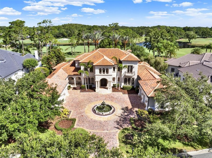Luxury Living in Lake Nona Golf & Country Club
9589 Blandford Road | 6,101 SF | 5 Beds | 6.5 Baths | Theater | Golf & Pond Views
Perfectly positioned in the renowned Lake Nona Golf & Country Club, this reimagined 6,101-square-foot Mediterranean estate seamlessly blends timeless elegance with modern sophistication. With sweeping golf course and tranquil pond views, this meticulously crafted residence invites you to experience the pinnacle of luxury living.
From the moment you arrive, the home makes a lasting impression with a grand stone paver driveway, striking fountain centerpiece, and lush, manicured landscaping. Inside, a dramatic two-story foyer with a sweeping staircase and sun-drenched interiors welcomes you to a space where architectural design and quality craftsmanship converge.
This exceptional estate offers five spacious bedrooms and six full bathrooms plus one half bath, including a luxurious first-floor primary suite featuring spa-inspired finishes, expansive walk-in closets, and peaceful views of the private outdoor oasis. A main-level guest suite provides flexible accommodations ideal for multigenerational living or long-term guests.
Designed for comfort and convenience, the home also features a private theater room for immersive entertainment, and an oversized executive office perfect for working from home. Formal and casual living spaces flow effortlessly throughout, adorned with custom millwork, designer finishes, and thoughtful attention to every detail.
At the heart of the home lies the gourmet chef’s kitchen, equipped with top-of-the-line appliances, a large center island, custom cabinetry, and a spacious walk-in pantry. The open-concept design connects the kitchen to the living and dining areas and extends seamlessly to the outdoors—perfect for both intimate family gatherings and large-scale entertaining.
Step outside to enjoy a resort-style pool and spa, surrounded by a covered lanai with a fully equipped summer kitchen, ideal for year-round outdoor living. Additional amenities include a four-car garage plus a dedicated golf cart garage, and a whole-house generator for added peace of mind.
Ideally located just minutes from Orlando International Airport, Lake Nona Medical City, USTA National Campus, Boxi Park, and top-rated A-schools, this property also offers easy access to the 417 Greeneway and 528 Beachline.
9589 Blandford Road is more than a home—it’s a lifestyle. Set in one of Central Florida’s most coveted gated communities, this is a rare opportunity to own a custom estate where luxury, privacy, and convenience meet.
Don’t miss out on this unique offering—schedule your private tour today.