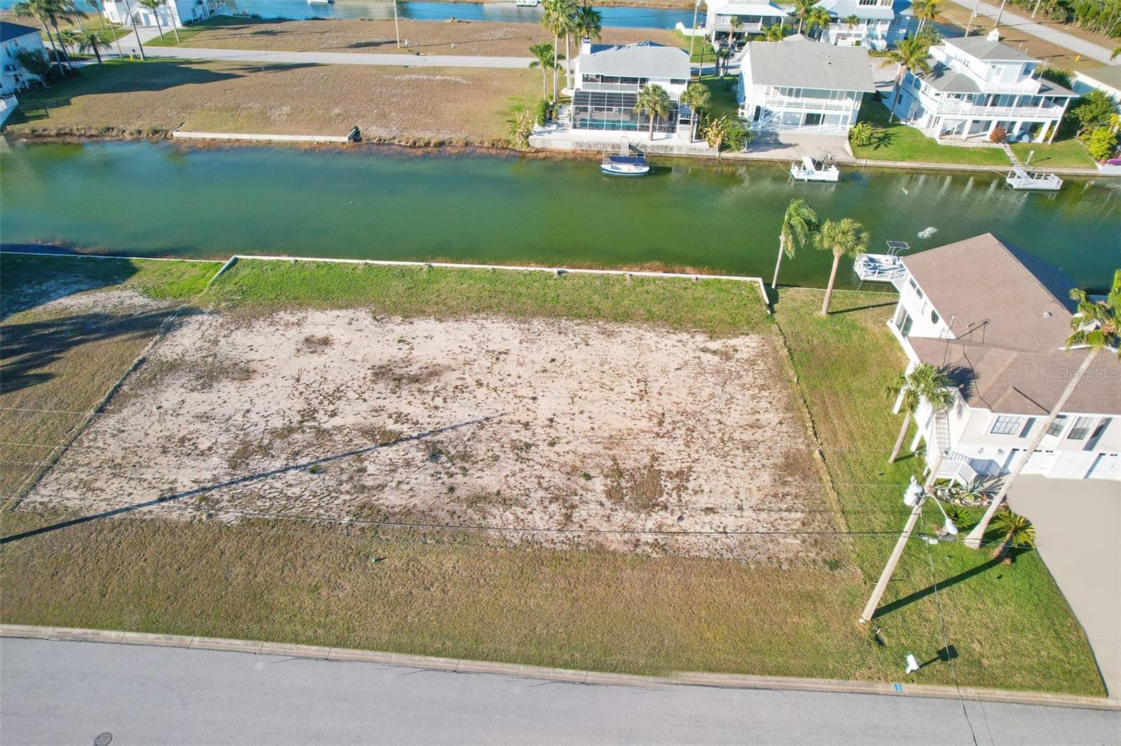 This exceptional 75 ft x 100 ft lot in Hernando Beach South offers the perfect opportunity to design and build your dream home. With a rear southern exposure, you can enjoy the warmth of the sun all day long. The lot is located in Hernando Beach, a hidden gem nestled within the Weeki Wachee Preserve, where nature and modern convenience come together seamlessly. Hernando Beach South is a charming community that offers a variety of restaurants and shops, all within walking distance. You'll also have easy access to the beauty of the Weeki Wachee Springs and the Weeki Wachee River, both just minutes away. Whether you're looking for adventure or relaxation, there are endless opportunities for recreation and exploration. One of the great features of this lot is that there is already a 4 ft sea wall built, providing added protection. Additionally, the modest $306 annual homeowners association fee not only covers lawn maintenance until your new home is complete but also gives you access to the community boat ramp. This is perfect for water enthusiasts who want to spend their weekends on the Hernando Beach "Flats" or take a boat ride to Anclote or the Homosassa River. Imagine the breathtaking views you'll have from the third story of your dream home. You'll be able to see the serene preserve and the sparkling Gulf of Mexico. With on-site survey and soil test data available, you'll have all the information you need to plan and build the home you've always wanted. Don't miss out on the chance to create the life you've always dreamed of in this idyllic haven. This isn't just a house, it's a blank canvas for your dreams and a gateway to an extraordinary coastal lifestyle.