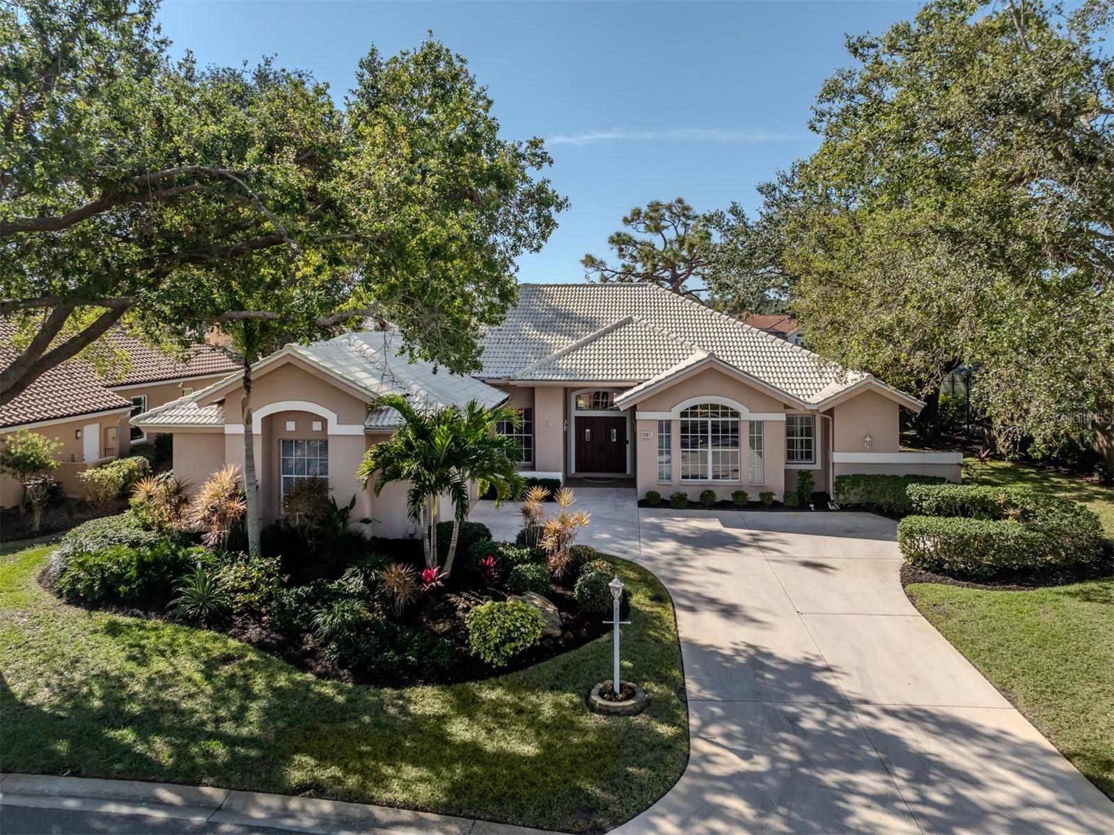 Magnificent and with modern flair, three-bedroom, three-bath custom-built Roll Construction residence in The Venice Golf and Country Club surrounded by well-manicured and mature landscape. Located on a quiet street overlooking the fifth fairway on the golf course and sparkling lake beyond, this property wows and welcomes you to your Florida oasis. A long driveway leading to a side entry oversized two-car garage provides an elegant front elevation. Step inside the stained glass double front doors to 16 ft. vaulted ceilings with architectural wall openings overlooking a combined formal dining room and living room with three panel disappearing glass slider doors to the spacious pool and spa lanai. A desirable open and split floor plan is complimented by the tall ceilings and etched glass transoms over every doorway. Chef style kitchen is complete with a gas range, walk-in pantry, breakfast bar and lanai serving window. The adjacent breakfast nook with four amazing skylights, large window and two sets of glass double doors leading to the pool and spa lanai presents an open and bright cheerful living environment. A spectacular lanai view overlooks the fifth fairway and lake beyond, a long pool and spa, multiple sitting areas and a grilling station complete the picture-perfect outdoor living space. The home office/den is conveniently located in the front of the residence with French double doors, an oversized window, ceiling trim and other details that delight the discriminating eye. Adjacent to the office rests the spacious primary bedroom with a new air conditioner installed in June 2025, large windows, trim work, a door to the lanai and two walk-in closets. The primary bath enjoys updated lighting, a dual sink stone top vanity, step-up soaking tub, private Roman shower and water closet. The preferred split-floorplan features a second generously sized bedroom with door sliders to the lanai and its own private bathroom that can double as a pool bath. The third bedroom is suitable for guests or family members with another full bath located just outside the door. The Venice Golf and Country Club is a premier, gated, member-owned and highly desirable friendly community. The recently renovated and expanded Clubhouse footprint includes a large fire pit for gathering, new gourmet and commercial kitchen, an additional large gathering bar and a state-of-the-art wellness center with massage, exercise classes, yoga, physical therapy and personal training. The treasured renovated Ted McAnlis 18-hole championship golf course, Har-Tru tennis courts, pickleball, bocce ball and a Junior Olympic pool and spa create an active yet relaxing lifestyle. The VGCC is a geo-certified Audubon Society with an A+ financial rating. Conveniently close to airports, shopping, restaurants, Interstate 75, theater, cultural events, Wellen Park, Atlanta Braves spring training ballpark and a world-renowned city on the Island of Venice with treasured beaches boasting 14 miles of open coastline. Experience all The Venice Golf and Country Club's lifestyle has to present. Unlock the extraordinary.