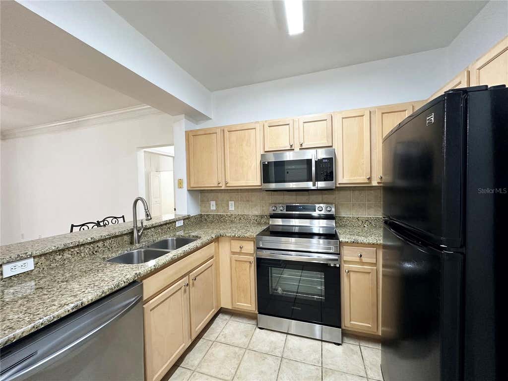 Photo of 12843 Madison Pointe Circle E #201, Orlando, FL 32821 (MLS # O6429837)