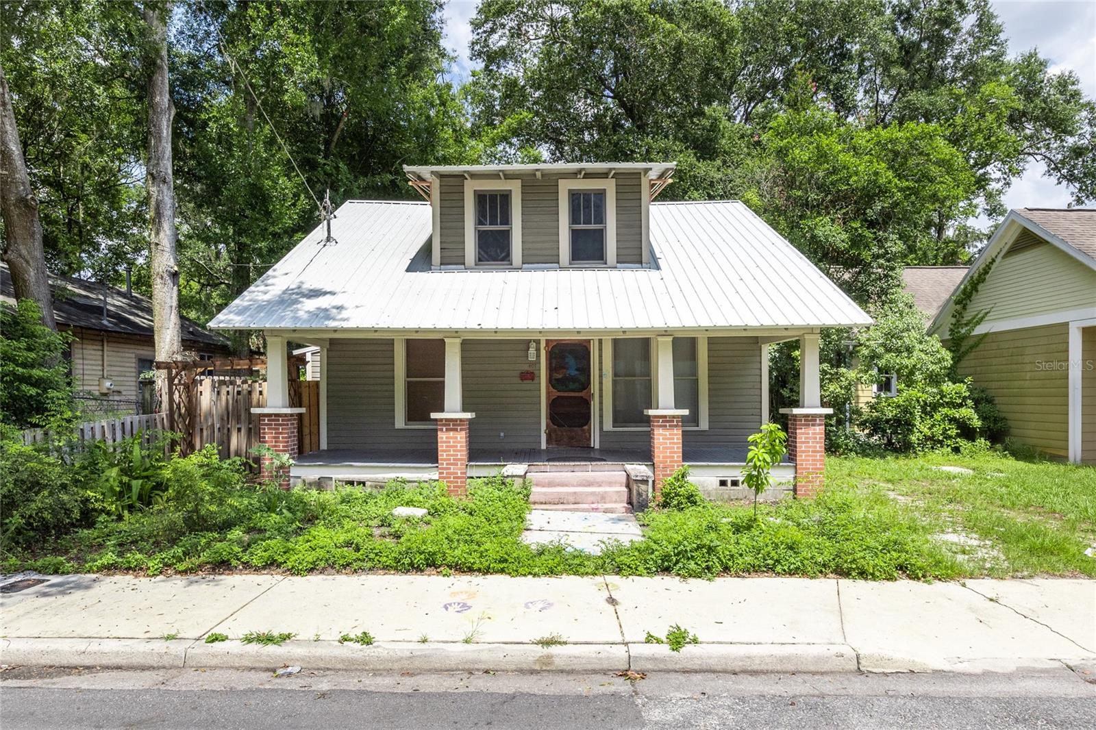 Great home with an amazing yard with a guest cottage with half bath. This home is close to the University of Florida and 13th Street. Located close to downtown, restaurants, and shopping. There is so much charming detail and a large updated kitchen. The wood work in this home is fantastic and has that craftsmanship that you do not see much of anymore. The homes comes with a lifetime Ram Jack warranty on the structure. Outdoor kitchen patio area with plenty of space. This beautiful, well maintained, historical home is a must see.