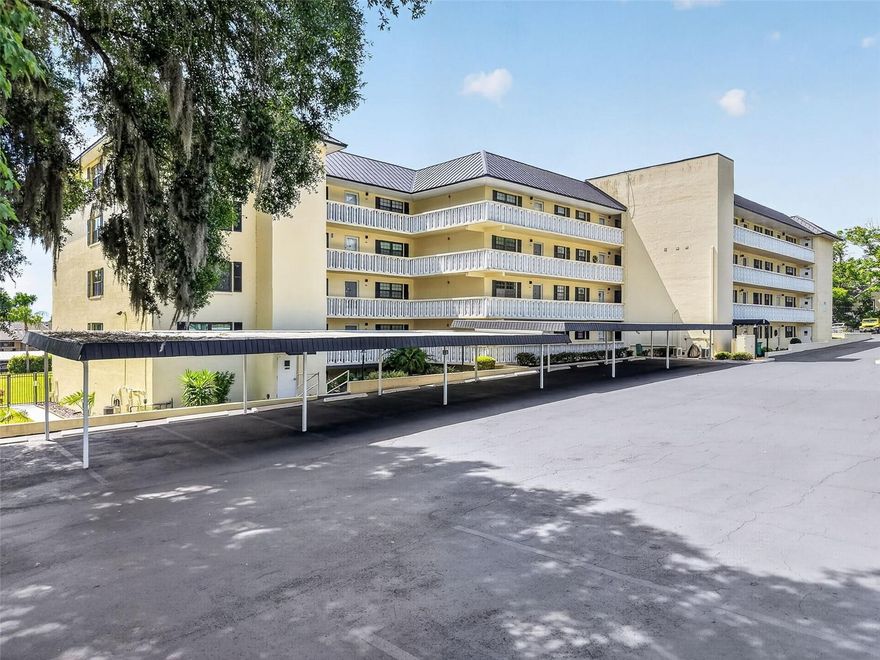 Perfectly positioned just moments from the heart of Historic downtown Mount Dora, this completely renovated garden-style condo offers a rare blend of luxury, privacy, and modern convenience. Completed in January 2025, Unit 1 is the only residence in the community with direct walkout access to the pool and grilling area, creating an effortless indoor-outdoor lifestyle while also enjoying the privacy of having no adjacent neighbors. Southern Oaks is a well-maintained, 55+ community offering a relaxed lifestyle with great amenities — including a heated pool, shuffleboard courts, clubhouse, workshop, designated storage, two community laundry rooms, and elevators — all surrounded by tranquil, landscaped grounds. Inside, the expanded kitchen was thoughtfully redesigned with timeless white Shaker cabinetry featuring soft-close doors and drawers, quartz countertops, striking Zellige tile backsplash, and abundant storage including large pot and dish drawers and a built-in pantry with rollout shelving. A full suite of Samsung SmartThings™ stainless steel appliances elevates the space with smart technology, including a counter-depth refrigerator with dual icemakers, internal auto-fill water pitcher, induction range with air fry convection oven, and app-controlled functionality. A built-in 30-inch wine and beverage center completes the kitchen’s sophisticated design.
The open living and dining areas are accented by custom beamed ceilings, recessed lighting, smooth-finish ceilings throughout, and polished concrete floors that create a clean, contemporary aesthetic. Every detail has been carefully curated, from the solid-core doors and oversized 5½-inch baseboards to the custom trim work and top-down/bottom-up shades throughout the home.
Both bedrooms enjoy ensuite-style bath access, including a beautifully redesigned guest bath with a walk-in tiled shower featuring rainfall, body spray, and handheld fixtures behind custom glass doors. The expanded primary suite offers a true spa-like retreat with a luxurious walk-in shower featuring rainfall, waterfall, body spray, handheld fixtures, and integrated Bluetooth™ speaker system, along with a floating double vanity illuminated by subtle low-voltage lighting. Raised ceiling details and a stylish fandelier enhance the primary bedroom, while custom Elfa™ closet systems maximize storage throughout the home.
Additional upgrades include dual hot water heaters, a whole-house dual water filtration system, whisper-quiet humidity-sensing bath fans vented to the exterior, new storm doors at the entry and screened lanai, and recessed lighting throughout key living spaces. This exceptional condo combines thoughtful design, high-end finishes, and an unbeatable location near the shops, restaurants, waterfront, and charm of downtown Mount Dora. This condo is perfect as a full-time residence, seasonal retreat, or investment property, delivering the best of Mount Dora’s friendly community and vibrant lifestyle.