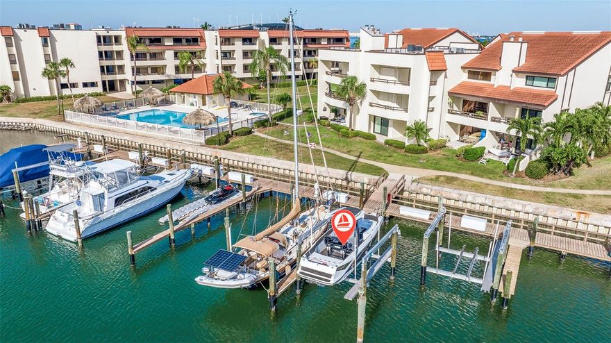 NEW PRICE ON THIS GORGEOUS WATERFRONT TOWNHOME!! Freshly updated, bright and light townhome with boat slip and 10K boat lift! Recent updates: flooring, high impact sliders on all levels, the staircase to upper loft and extended primary closet! LIVE THE ISLAND DREAM! Water views and a private boat slip are the main features in this freshly updated 2-bedroom + loft, 2.5-bathroom townhouse. Experience the epitome of Florida living in this home perfectly nestled in a vibrant waterfront pet-friendly community. As you ascend the contrasted espresso wood stairs, you're welcomed into the living room, where sunset water views, a wood-burning fireplace, convenient luxury vinyl flooring, and an open floor plan seamlessly connect to the dining room and kitchen. The main living floor is flooded with light. It features two balconies, providing perfect spots for relaxation with sunrise coffee or sunset drinks, whether in the kitchen or living room, with easy access to the downstairs area and nearby pool. The kitchen is a gourmet's dream with rich espresso cabinets, exquisite white quartz countertops, and a spacious island for culinary enthusiasts. Brand-new upscale appliances complement the contemporary design, while a barn door pantry and discreet laundry closet add convenience. A powder room completes this level. Upstairs, the primary suite offers a generous high-ceiling retreat with its own balcony boasting sunset views. The oversized bathroom is freshly updated. Ascend another set of comfortable stairs to discover a loft for office or other needs. The updated primary offers 2 walk-in closets. On the opposite side, the second-bedroom suite enjoys its balcony with northeast exposure, perfect for morning sunlight and great newly updated bathroom. Guests will relish the privacy of this balcony. The garage comfortably accommodates two tandem cars and features a sliding door providing access to the rear porch and grill area. A short stroll leads to one of three community pools and your private boat slip. This versatile space can also serve as an overflow guest area or workshop, complete with the convenience of a quiet split AC unit. The garage floor showcases a stunning epoxy sealife design that adds a unique touch. Your boat slip, initially 14 x 40’ ( with potential for expansion ), comes complete with a state-of-the-art 10K Deco boat lift installed in 2022, ensuring effortless access to your boat just steps from your property. This home is situated in a 24/7 guard gated community featuring a clubhouse with a kitchen, library, fitness room, three heated pools ( heated or chilled), tennis courts, and a marina area to serve the community. This community is on top of its Milestone Inspection with no concerns, the HOA fees cover exterior and flood insurance, and the current condo fee reflects the latest updates. Enjoy walking distance to restaurants, a bike trail, and a beautiful new bridge ideal for walking or bike rides. Plus, you're just a short drive away from the pristine beaches Florida is known for and a mere 10 minutes from the bustling downtown of St. Petersburg. Pets allowed, also available for rent.