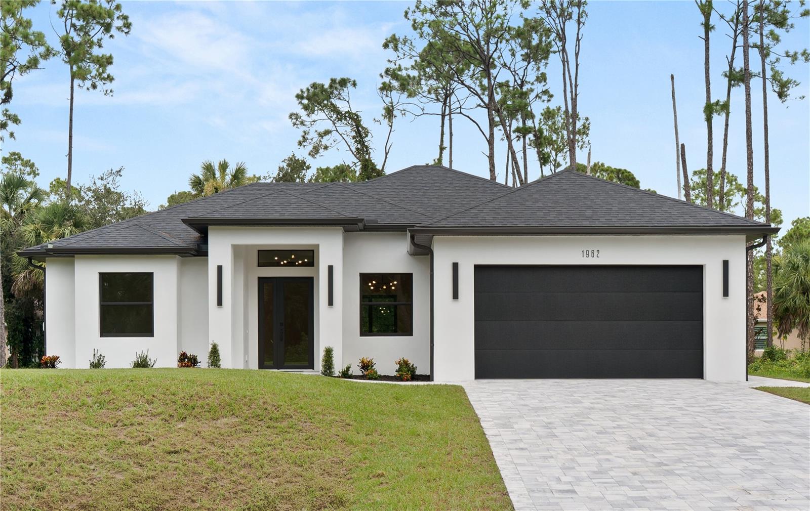 One or more photo(s) has been virtually staged. Welcome to this beautifully designed 3-bedroom, 2-bathroom home in North Port, Florida, where modern elegance meets everyday comfort. From the moment you arrive, the home makes a statement with its extra-wide pavered driveway, offering both style and convenience while enhancing the overall curb appeal.
Step inside and you’ll be greeted by an open and airy layout highlighted by high ceilings that create a sense of spaciousness and light throughout the home. Every detail has been thoughtfully considered, with luxury upgrades that elevate each room. The great room flows seamlessly into the kitchen and dining areas, making it the perfect setting for both relaxed living and entertaining.
The kitchen is a standout feature, combining style and functionality. Upgraded finishes, modern cabinetry, and sleek countertops provide the perfect backdrop for preparing meals, while stainless steel appliances add both performance and sophistication. Large impact windows invite natural light to pour in, brightening the interiors while also offering peace of mind and storm protection.
The primary suite is a true retreat, designed with both comfort and elegance in mind. This spacious room features ample closet space and a beautifully finished en-suite bathroom, complete with dual sinks and a walk-in shower. The additional bedrooms are generously sized, offering flexibility for guests, work, or hobbies.
Step outside and enjoy the Florida lifestyle with plenty of room for outdoor living and entertaining. Whether it’s relaxing on the covered patio, adding a pool, or creating your own garden oasis, the possibilities are endless.
Located in the growing community of North Port, Florida, this home combines high-quality construction, thoughtful design, and modern finishes with a convenient location close to shopping, dining, parks, and easy access to both US-41 and I-75.
Blending beauty, durability, and functionality, this home offers everything needed for comfortable living in one of Southwest Florida’s most desirable areas.