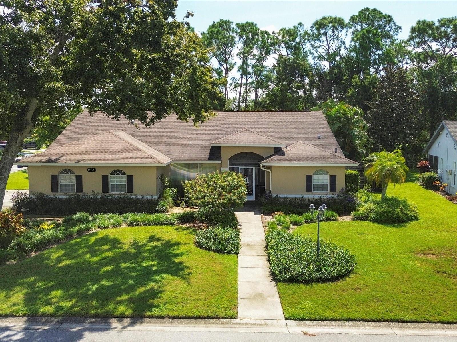 Welcome to your private sanctuary, nestled on a beautifully landscaped, nearly 3/4-acre corner lot. This meticulously maintained 2,052 sq. ft. home offers the perfect blend of comfort, style, and privacy in a serene garden-like setting. The 3-bedroom, 2-bathroom layout features a thoughtful split floor plan that balances space and seclusion. An open-concept living area invites easy entertaining, with large windows showcasing garden views and a seamless flow to the outdoors. The kitchen offers generous counter space and abundant storage. Step outside into a tranquil oasis, complete with winding garden paths and lush landscaping. The fully fenced yard provides a secluded retreat, ideal for relaxation or gatherings. Enjoy cozy evenings around the striking Aztec-inspired outdoor fireplace — a stunning centerpiece for entertaining under the stars. With multiple indoor and outdoor living areas, this lovingly cared-for home is perfect for both peaceful retreats and lively get-togethers. Its prime location, expansive lot, and pristine condition make it a rare find. Schedule your private tour today and discover the charm of this exceptional property.
