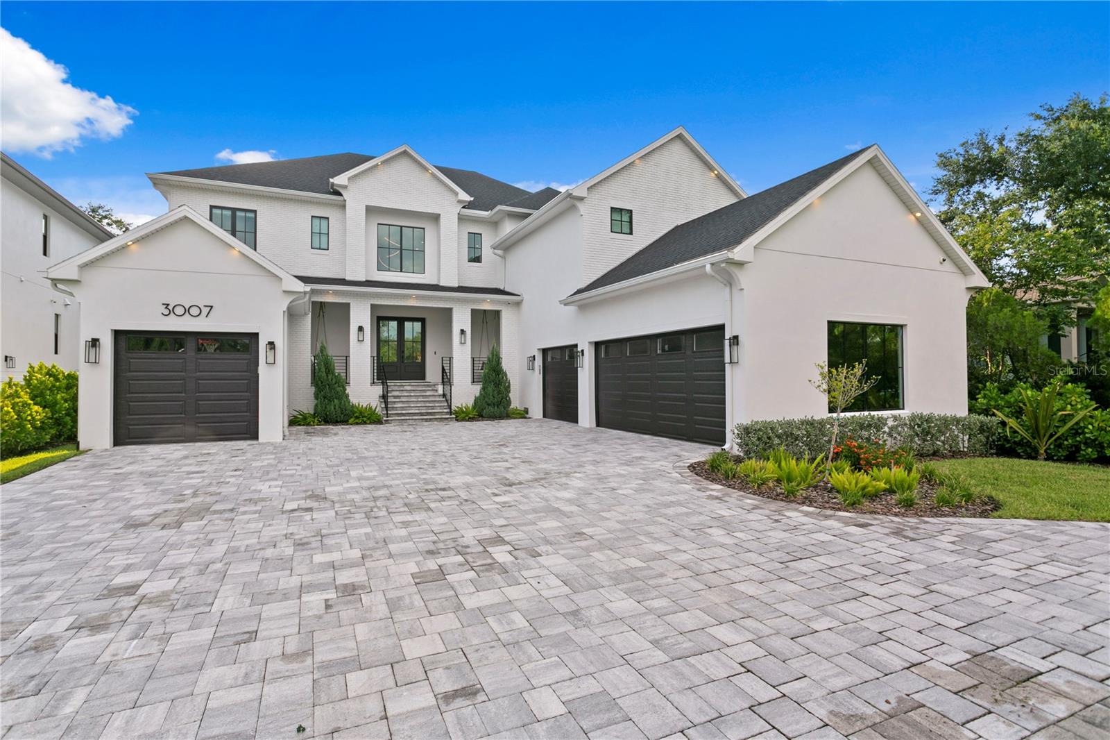 Exceptional luxury estate in the heart of South Tampa's desirable Sunset Park neighborhood. Encompassing over 7,500 square feet under roof and 5,548 square feet of heated living space, this stunning residence offers 5-Beds, 5.5 Baths. The home includes both a first and second floor primary suite and can be available fully furnished.
Enter through a private gated entrance surrounded by lush landscaping and into a grand two-story foyer. The home boasts an open-concept layout with soaring ceilings and abundant natural light. A chef-inspired kitchen features a Wolf 48" dual fuel range, Sub-Zero refrigerator, Bosch dishwasher, and Zephyr beverage cooler. The expansive island and wet bar seamlessly flow into a spacious 25’ x 25’ great room and formal dining room. A walk-in pantry and a Butler’s pantry add additional functionality.
Indoor-outdoor living shines through 16’ wide sliding glass doors that open to a large covered lanai featuring an outdoor kitchen and dining area. Enjoy resort-style amenities in the private and oversized backyard with a custom-designed 14’ x 24’ pool with sun shelf and spa, outdoor fire pit, low-maintenance turf and ample space for entertaining.
Upstairs, the second primary suite offers a spa-like bath with a soaking tub framed by a picture window, glass-enclosed shower with multiple heads, dual vanities, and a custom closet with island storage and display wall.
The home also includes a dedicated office, bonus/media room, wine room with tasting area, and two laundry rooms. Notable features include custom cabinetry, engineered hardwood flooring, crown molding, LED accent lighting, motion-activated bathroom lighting, and pre-wiring for security, audio, and generator.
Ample parking options include a three-car space and an additional single-car garage, both with electric car charging stations and a spacious paver motor court. The home also features impact-rated windows, tankless gas water heaters, spray foam insulation, and upgraded electrical throughout.
Enjoy proximity to top-rated schools, fine dining, Westshore Marina District, International Plaza, Tampa International Airport, and vibrant downtown Tampa. This home offers a refined lifestyle with impeccable design while situated in a convenient location. Schedule your private showing today to experience this exceptional home firsthand.