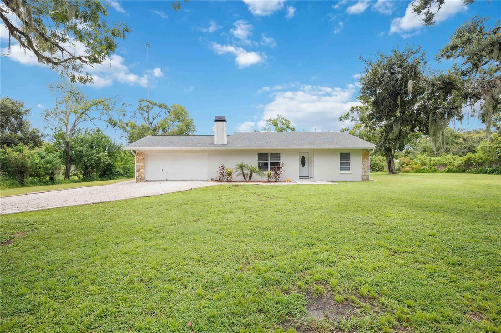 Completely Renovated 3/2/2 pool home on 1+ acre - Zoned Agricultural. Discover this hidden gem just minutes from SR 64 and I75! This stunning home has been thoughtfully renovated for modern living. Step inside to bright, open spaces with porcelain plank tile throughout, a cozy fireplace, and a chef-ready kitchen featuring brand new LG Appliances. Relax or entertain in the screened, heated pool and spa area, complete with an outdoor Alexa Sound System. Both bathrooms are beautifully upgraded, offering a spa-like feel. With over an acre of land, this property provides endless possibilities: Farming, an Outbuilding for your business needs, RV, Boat, or Auto Storage. Enjoy the freedom of no HOA or Deed Restrictions while making this versatile, move-in-ready home your own. Don't miss your chance to own this exceptional property that combines privacy, convenience and endless potential.