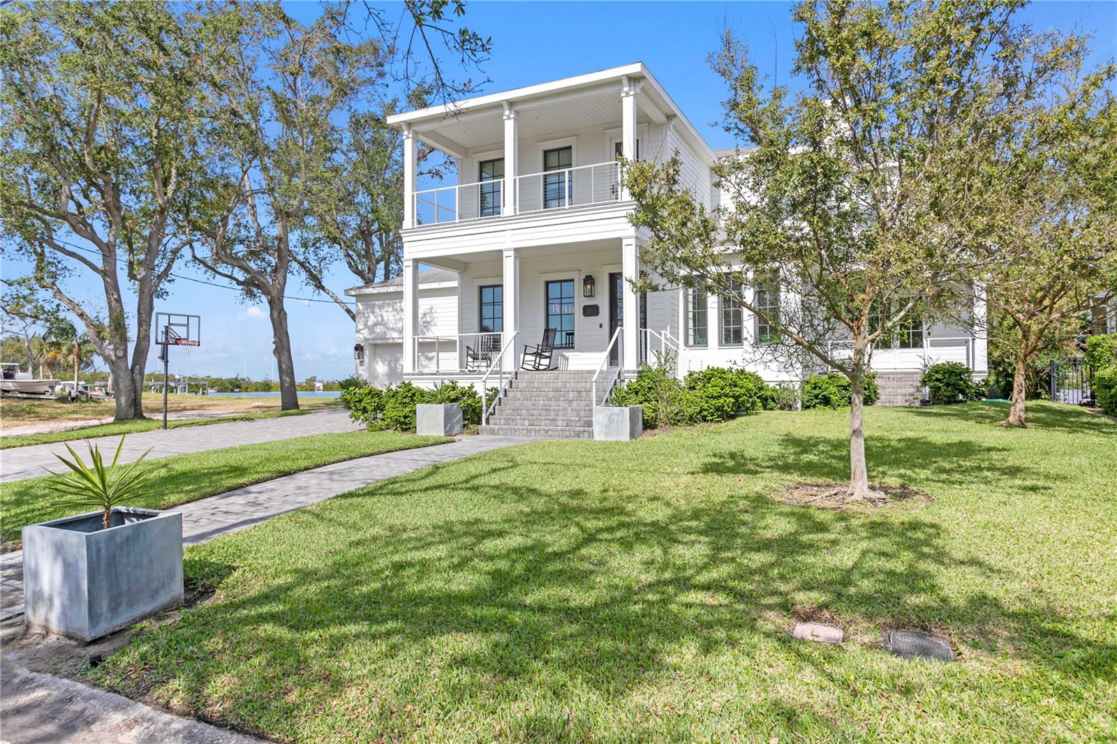 Minutes to the OPEN BAY and nestled among the shore of Tampa's coveted BEACH PARK neighborhood, this extraordinary 5-bedroom, 5 1/2 bath plus office, WATERFRONT home features over 5,000 sf of living spaces, all block construction, insulated impact windows/doors and an unparalleled blend of modern luxury and timeless craftsmanship including gas lanterns and white oak herringbone pattern reclaimed wood floors from the Biltmore Hotel. This custom-built home is perfectly situated on a 10,000 square foot waterfront lot offering stunning views, a saltwater pool, paver patio, private dock with boat lift and direct boating access to Tampa Bay. First floor features formal living and dining spaces, great room with gas fireplace, chef's kitchen with Wolf and Sub-Zero appliances, 170-bottle wine room, a generous sized en-suite bedroom, office/study room, downstairs laundry and pool bath. Upstairs the luxurious primary suite offers water views, a private balcony, and a spa-like bathroom with separate vanities, a soaking tub, oversized walk-in shower and dual water closets. 3 additional bedrooms, 2 full baths and an upstairs laundry room complete the second floor. Located in a top-rated school district just minutes to Tampa International Airport, International Plaza, Downtown Tampa, shopping, restaurants, sporting venues and providing easy access to all local bridges. Attention to detail and design throughout makes this home a must see!