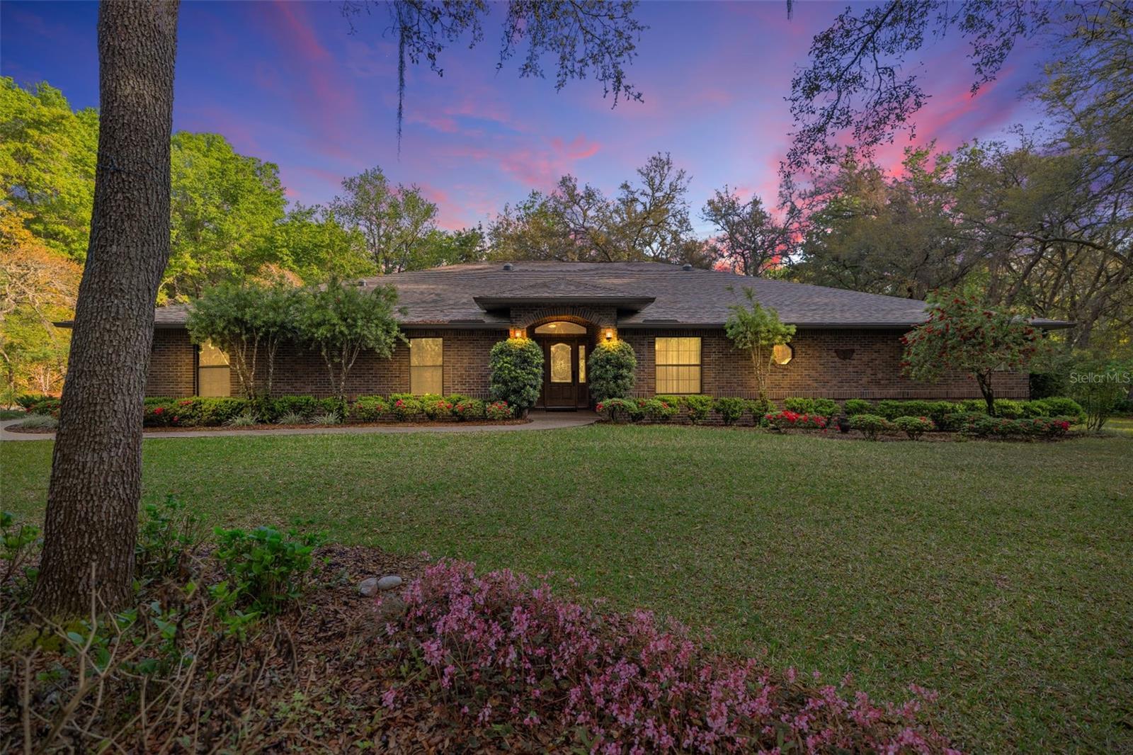 Welcome to an exceptional custom-built estate offering timeless craftsmanship, thoughtful design, and privacy on just under 5 beautifully manicured acres. This stunning four-bedroom, two-bathroom home spans nearly 2,800 square feet and was masterfully constructed by TL Carlson, with the owners instructing that only top-of-the-line materials and finishes be used throughout. Full brick and block walls provide lasting quality and energy efficiency, while every bedroom includes a walk-in closet with automatic lighting—just one of many touches you won’t find in most custom builds. The kitchen, laundry room, and all vanities feature solid wood maple cabinetry—a rarity in today’s market—along with deep storage options, three Lazy Susans, built-in pantry, and abundant pullouts for maximum functionality. Recent upgrades include newer appliances, a brand-new roof, seamless gutters with gutter guards, and a fully automated irrigation system. Step outside to enjoy the solar-heated, screen-enclosed saltwater pool surrounded by pavers and a thoughtfully landscaped setting designed by a master gardener. The oversized garage and extended driveway offer ample parking, while the home itself is equipped with an in-wall pest system and an active termite bond for peace of mind. Backing up to horse farms on both Baseline Road (FL-35) and State Road 326, this property offers a rare blend of rural privacy and accessibility. You’ll be less than a mile from State Road 40—a key east-to-west route in Florida connecting Daytona to Dunnellon—offering easy access to shopping, dining, and everyday conveniences. Outdoor enthusiasts will love being within a mile of three separate state forests, each spanning approximately 5,000 acres. And best of all, this home sits in Flood Zone X, a non-flood zone for added assurance. Appraised at $975,000 on March 17, 2025, this property is now priced well below appraised value, and the seller is extremely motivated. If you’re searching for a home where every detail was carefully considered—from materials to layout to setting—this is one you must see in person. Don’t miss the opportunity to experience a truly custom masterpiece. Schedule your private showing today and come see the difference quality makes.