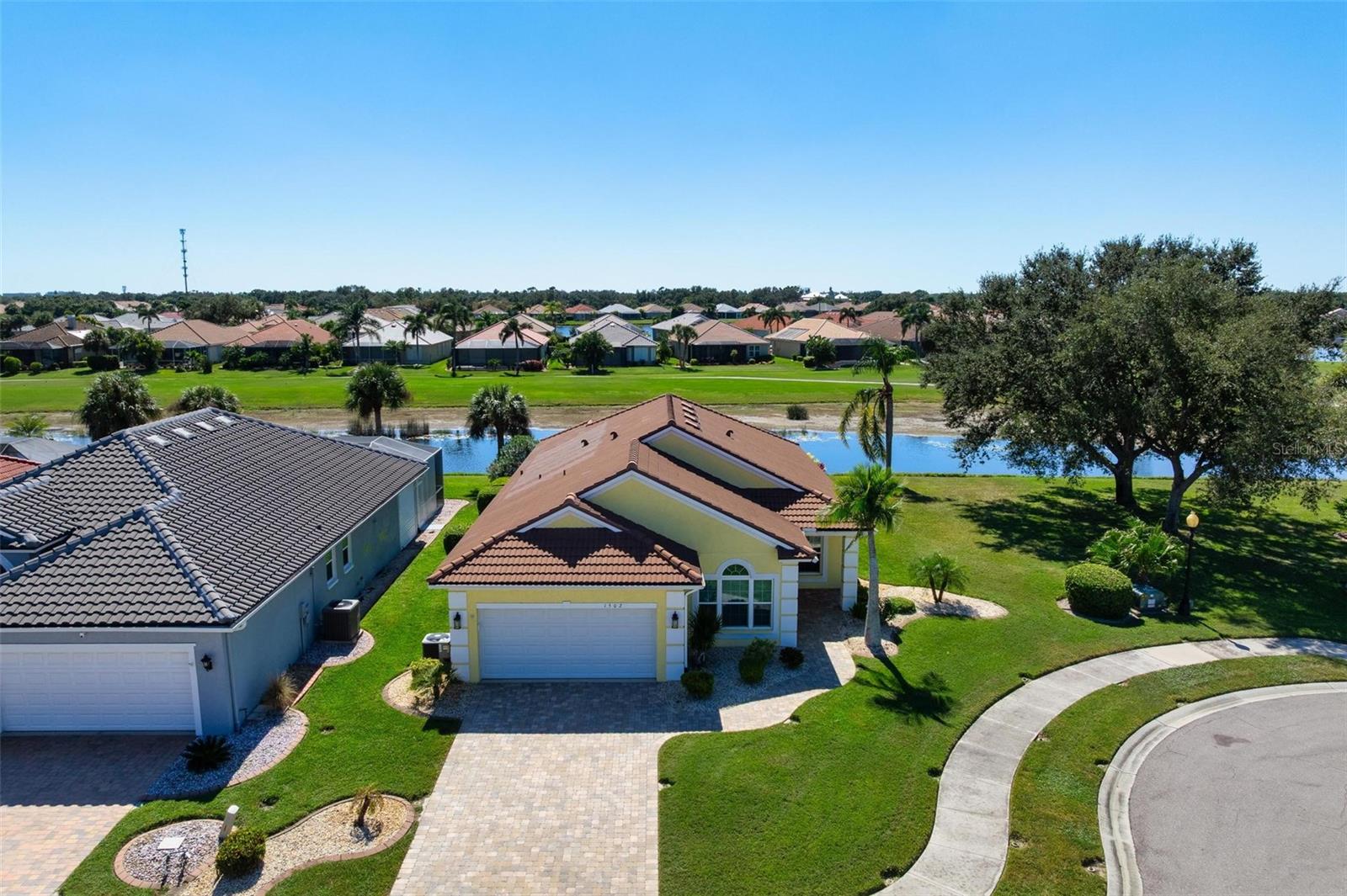 One or more photo(s) has been virtually staged. Rare indeed - remodeled and beautifully maintained. Nearly ¼ acre. Amongst the largest lots at Pelican Pointe. Sought after southwest rear exposure, with panoramic golf, lake, and wooded views. All hurricane windows, sliding doors, garage and front door (2020/2021). Tile roof (2022). Air Conditioner (2021). Electric pool heater (2022). Stylish greige-toned wood-look tile throughout (2023). Kitchen and baths feature tall white wood cabinetry and quartz counters. Walls painted in fresh coastal palette of soft and muted tones of blue and lemon. Open floor plan flows to a screened outdoor living area with refinished heated pool (2023). Epoxy garage floor for car or hobby enthusiasts (2024). Pelican Pointe offers 27 holes of semi-private golf, clubhouse dining, tennis, pickleball, fitness, pool, guard-gated entry, and full social membership included in low HOA fees. Just minutes to historic Venice Island, beaches, and cultural venues.