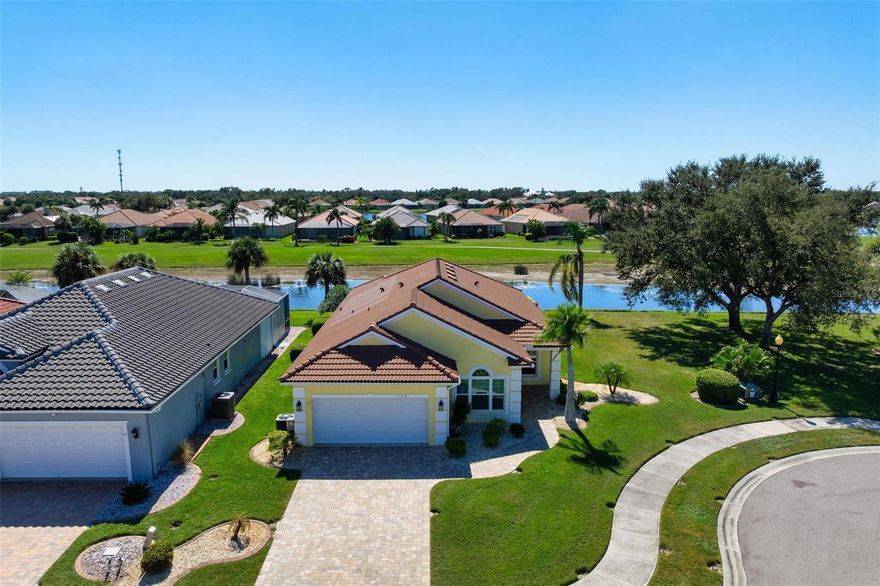 One or more photo(s) has been virtually staged. Rare indeed - remodeled and beautifully maintained. Nearly ¼ acre. Amongst the largest lots at Pelican Pointe.  Sought after southwest rear exposure, with panoramic golf, lake, and wooded views.  All hurricane windows, sliding doors, garage and front door (2020/2021). Tile roof (2022). Air Conditioner (2021). Electric pool heater (2022). Stylish greige-toned wood-look tile throughout (2023). Kitchen and baths feature tall white wood cabinetry and quartz counters. Walls painted in fresh coastal palette of soft and muted tones of blue and lemon. Open floor plan flows to a screened outdoor living area with refinished heated pool (2023). Epoxy garage floor for car or hobby enthusiasts (2024). Pelican Pointe offers 27 holes of semi-private golf, clubhouse dining, tennis, pickleball, fitness, pool, guard-gated entry, and full social membership included in low HOA fees. Just minutes to historic Venice Island, beaches, and cultural venues.