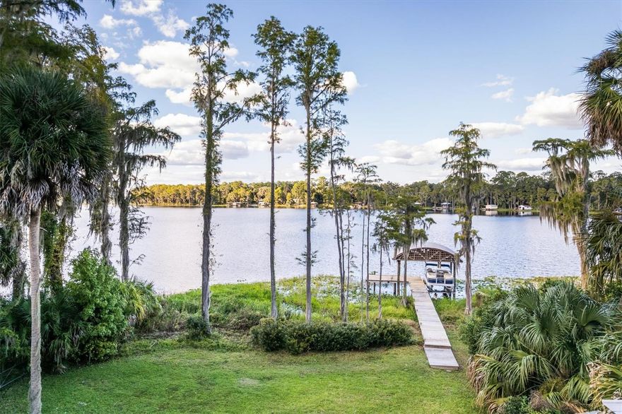 Welcome to your Lake Retreat on Melrose Bay, Lake Santa Fe! Designed by renowned architect Ron Haase, this iconic, Old-Florida style home was designed as his family’s personal lake retreat. Filled with natural light, the open-concept great room, kitchen, and dining area create a warm, airy space ideal for both relaxed living and effortless entertaining. The kitchen features elegant stone countertops, brushed chrome appliances, and a cozy breakfast bar—perfect for greeting the sunrise through the easterly windows! Dine indoors or step onto the elevated deck and screened lanai to enjoy lake breezes and gorgeous sunsets! Thoughtfully designed to embrace Florida’s natural beauty, the home showcases wide overhangs, cedar trim, new wood flooring throughout, metal accent siding, cedar-lined closets, and Pella windows throughout—blending craftsmanship with timeless style. Nestled in the heart of historic Melrose, Melrose Bay is a peaceful no-wake zone with direct access to Lake Santa Fe. The Lake is celebrated for its pristine water quality, excellent fishing, kayaking, paddle boarding, and swimming! Enjoy the conveniences and activities of the eclectic Melrose community AND the serenity of this home and property. it is an easy walk, bike ride or golf cart trip from the property to Melrose for dining, art galleries, and supplies.  Melrose is just 30 minutes from Gainesville, 20 minutes to Gainesville Regional Airport, and 90 minutes to Jacksonville. Experience the perfect harmony of architectural elegance, lakeside tranquility, and classic Florida charm in this one-of-a-kind waterfront home!