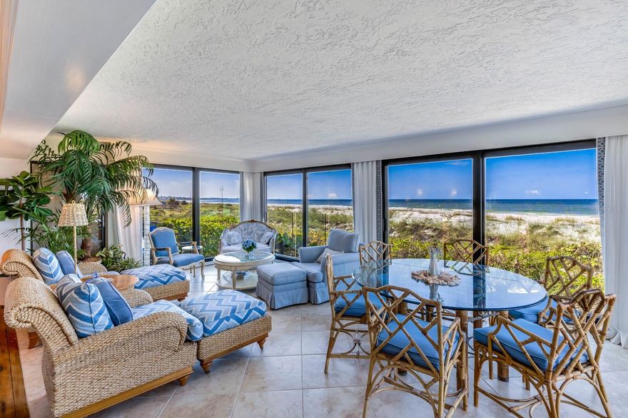 One or more photo(s) has been virtually staged. Escape to your dream beachfront oasis with this stunning end unit at Beach Manor, nestled within the coveted Boca Grande Club—an upscale, gated waterfront community. Revel in the serenity of direct beach access, with this unit perfectly positioned on the sand, offering unparalleled views of the Gulf of Mexico from both inside and the private sundeck.

Enjoy a generous interior, creating a spacious retreat ideal for coastal living. Step outside to the secluded beach, or unwind inside this immaculate 3-bed, 3-bath haven featuring a bright, open floor plan. Renovated in 2018 by Schmehl and Harkness and refreshed by the current owner, discover clear railings for enhanced views, distressed chestnut floors, a gas fireplace, chic wallpaper, Kohler Spa Tub, remote control shades, and hurricane-resistant sliders.

The building itself exudes quality, boasting a new roof, fresh paint, restored concrete, and all-new balconies. Benefit from on-site housekeeping, maintenance, private parking, a nearby pool, and golf cart charging stations. Residents indulge in resort-style amenities, from a top-rated tennis club to a fully-equipped fitness facility. Dine in the exclusive gulf-front clubhouse restaurant, relax at heated swimming pools or the Tiki bar, and savor sunset views.

Seize this rare opportunity to own a slice of paradise on one of the most beautiful and remote stretches of beach. Contact us now to schedule a showing and immerse yourself in the ultimate beachfront lifestyle!