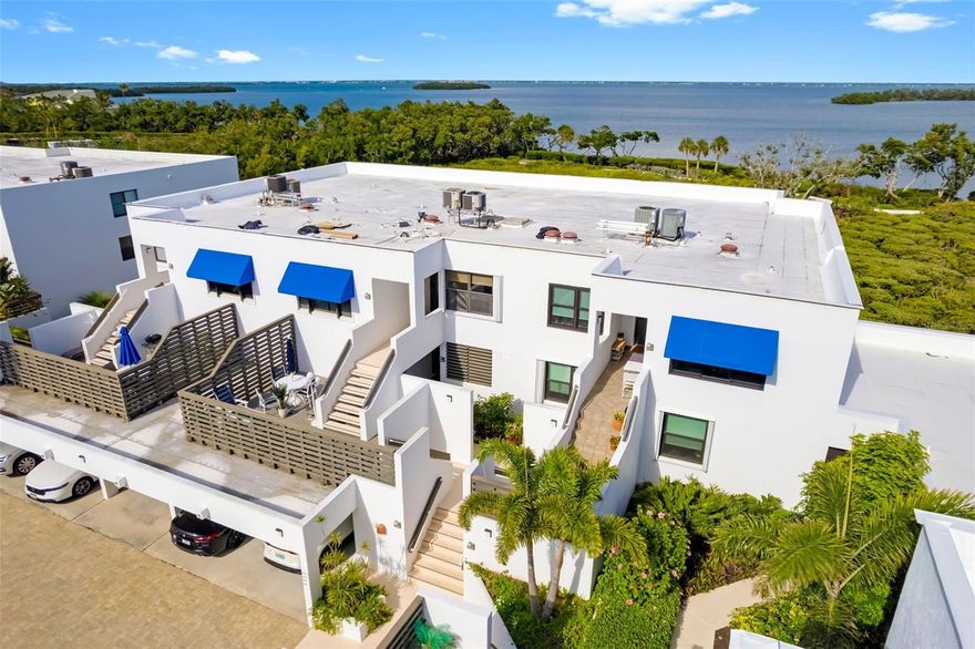 Welcome to a true hidden gem of tropical paradise at Bayport Beach and Tennis Club on Longboat Key. Designed by renowned architect Tim Seibert, this one-of-a-kind community spans 27 lush, tropical acres and offers an unmatched coastal lifestyle with 1,200 feet of pristine private beach, where chairs and umbrellas are ready for you to enjoy endless days along the Gulf.

As you arrive, you’re immediately surrounded by beautifully maintained grounds and the relaxed, resort-style atmosphere that makes this community so special. Stepping inside this spacious 2 bedroom, 2 bathroom furnished residence, you’re welcomed by a light and airy interior with terracotta-look tile flooring flowing throughout the main living areas, setting a warm coastal tone.

The kitchen has been thoughtfully renovated with all new cabinetry, under-cabinet lighting, quartz countertops, a modern backsplash, and stainless steel appliances, creating a clean and functional space that opens seamlessly into the living and dining areas. The expansive living room is both inviting and impressive, designed to feel like a single-family home, with stunning Sarasota Bay views that instantly capture your attention. Shutter doors provide privacy while leading into a sunroom, offering a flexible space to relax and take in the scenery.

The owner’s suite is a true retreat, complete with a dedicated office nook perfectly positioned to enjoy peaceful water views. The ensuite bathroom features dual quartz-topped vanities and a walk-in closet, combining comfort and convenience. A split bedroom floorplan ensures privacy, with the guest bedroom offering its own walk-in closet and easy access to the updated guest bathroom. An in-unit laundry area adds to the everyday ease of living.

Step outside onto your expansive private deck, where breathtaking views of Sarasota Bay create the perfect backdrop for morning coffee, evening wine, or entertaining guests while surrounded by nature.

Bayport Beach and Tennis Club offers an incredible array of amenities, including a Junior-Olympic heated pool, four Har-Tru tennis courts, a fitness center, fishing pier, kayak storage + launch, and an active clubhouse filled with social events. Scenic walking trails wind through the property, where you’ll often spot local wildlife such as osprey, herons, ibis, and egrets, enhancing the serene, natural setting.

Just moments away, Bayfront Park offers pickleball courts, green space, and stunning bay views, while St. Armands Circle provides exceptional shopping and dining. A short drive over the iconic Ringling Bridge brings you into vibrant downtown Sarasota, known for its world-class arts scene, including theaters, museums, galleries, and waterfront dining.

From private beach access to unmatched amenities and breathtaking bay views, this residence offers the perfect blend of comfort, nature, and coastal elegance in one of Longboat Key’s most sought-after communities.