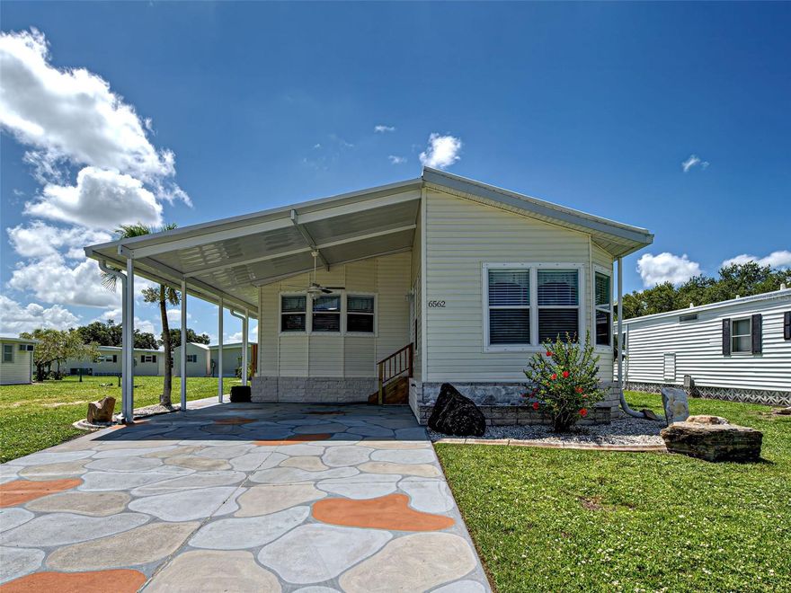 Welcome to the Quaint and Friendly Community of Holiday Park! This meticulously maintained home features 2 bedrooms and 2 full bathrooms with an open concept living room, dining room & kitchen. It also has a cozy family room with bay windows and huge Florida Room/Man Cave with a/c and fans. The kitchen has been updated with newer appliances. The Primary Suite features a double door entry with a large "walk-through" closet, and en suite bathroom with a large vanity, shower stall with bench and spacious linen closet. The second bathroom has been upgraded with a "walk-in" bathtub which is Fantastic at any age!! The home is being offered fully furnished making it the perfect Winter Retreat or for a full timer who wants to downsize to an active community. This newer built mobile home has vaulted ceilings, drywall construction (no fake wood paneling), vinyl siding and shingle roof with a reinforced rubber membrane. There is a huge workshop/shed with built in shelving and workbench for any tinkering or toys. It also has a double door for easy storage of the lawn mover and tools.