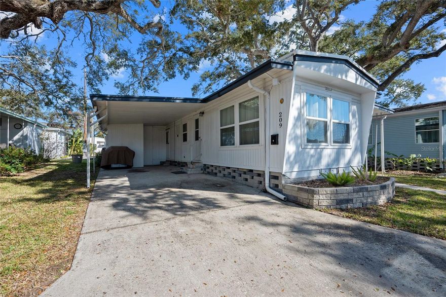 Welcome to this beautifully updated 2-bedroom home, thoughtfully renovated with stylish finishes and smart upgrades throughout. Designed for comfort and easy living, this residence is located in Sky Harbor Estates, an active 55+ waterfront community on the Bay offering direct access and a relaxed coastal lifestyle close to everything you need.  The fully renovated kitchen is a standout, featuring a wine/beer/beverage fridge, pull-out trash cabinet, pantry with pull-out shelving, under-cabinet lighting, and a water filtration system. An additional 150 sq ft enclosed sunroom (not included in heated square footage) provides flexible space for morning coffee, hobbies, or simply enjoying the Florida sunshine.  Inside, the home features two well-sized bedrooms measuring 12’ x 11.5’ and 11.5’ x 10.5’, with one bedroom offering a generous 3’ x 8’ closet. Both bathrooms have been completely remodeled, and the main living areas showcase updated flooring and windows for a fresh, modern feel. The laundry is conveniently located in the shed off the carport, keeping the interior open and uncluttered. Major improvements include a roof less than 5 years old and a brand-new central AC/heat system, offering peace of mind for years to come. With 768 sq ft of thoughtfully updated living space, this home blends modern comfort with the laid-back, coastal lifestyle that makes Sky Harbor Estates so special.