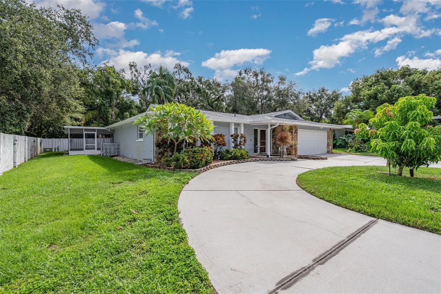 Beautiful 3 bedroom, 3 full bath, 2200+ sq/ft home with a 700+ sq/ft screened in patio!!!  This home has been lovingly maintained and cared for through the years and features a new roof, hurricane windows and sliders, and a new hot water heater.  Inside this home features a great open concept floor plan with a large tiled living and dining area open to a beautiful kitchen featuring high quality solid wood cabinets with lots of storage, granite countertops and backsplash, stainless steel appliances, a large peninsula, and an island.  The split bedroom floor plan features two bedrooms and a full bath on one side of the home, and a very private oversized primary suite on the other side.  The primary suite features beautiful cherry wood floors, a large walk in closet, an updated bath with a new shower, and plenty of counter space.  Outside this home features a huge screened in patio with a full bath attached, a private yard with irrigation in the front and back, an attached 2 car garage, and a large circular driveway with plenty of parking.  All this located at the end of a cul-du-sac in a great neighborhood convenient to beaches, airports, great schools, shopping, and all the other attractions of the Tampa Bay area!!!