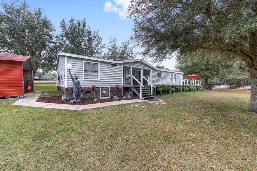Imagine mornings spent with a cup of coffee as deer and native wildlife move quietly on this peaceful 10-acre equestrian paradise in the heart of Ocala horse country. This super adorable, cedar-sided, beautifully remodeled home offers three spacious bedrooms, two full baths, a private office, and a laundry room, blending comfort with timeless charm. Expansive wraparound decks create a seamless indoor-outdoor lifestyle, perfect for entertaining or relaxing while overlooking the sparkling pool and serene landscape. This exceptional horse property features a brand new 10-stall center aisle barn, a separate tack and feed shed, plus an additional paddock with two private stalls and storage. Lush grass paddocks with excellent soil support healthy horses, while the pasture includes a jumping area, shaded pine hammock, and a level site ideal for a dressage arena, with additional land available for future paddocks. There's an RV hookup, and a two-car carport for vehicles or equipment. Surrounded on three sides by majestic oak trees, this farm offers outstanding privacy, quiet, and natural beauty. Ideally located less than 10 minutes to HITS, approximately 20 minutes to WEC Ocala, 5 minutes to the charming town of Williston, 15 minutes to Ocala, and 20 minutes to Gainesville. This is a rare opportunity to own a turnkey equestrian estate offering lifestyle, location, and land in one truly special setting.