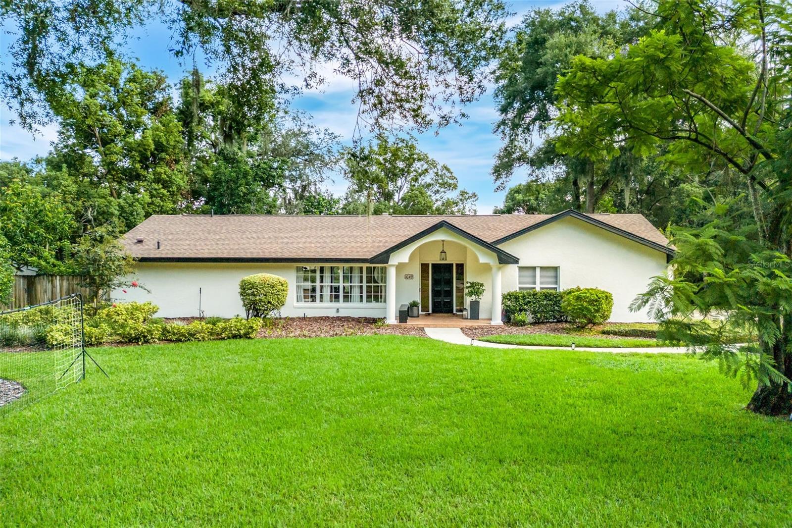 This is a rare opportunity to own a ONE STORY LARKEFRONT home on a HALF-ACRE lot in the highly desirable Via’s of Winter Park. Nestled on a quiet cul-de-sac in Tuscany Place and zoned for top A-rated schools, this beautifully maintained 4-bedroom, 2-bath home offers breathtaking views of Lake Temple from nearly every room. The spacious and light-filled interior features a split bedroom floor plan with a formal living room, dining room, and a comfortable family room—an ideal layout for any family. The kitchen is equipped with solid wood cabinets, granite countertops, and opens to the family room, which includes custom built-ins and a wood-burning fireplace with granite surround. Hardwood floors run throughout the home, and large windows flood the space with natural light. The primary suite overlooks the lake and includes a walk-in closet, dual sinks, a separate shower, and direct access to the screened-in rear porch. Three additional guest bedrooms are privately situated on the opposite side of the home. A spacious indoor laundry room leads to a side-entry two-car garage. Outside, the screened patio offers the perfect place to entertain while enjoying the pool, spa, and serene lakefront setting. Located just minutes from Park Avenue and the Winter Park Racquet Club, this unique property offers endless potential to live in as-is, renovate, or build new on one of the Via’s most coveted lakefront lots.