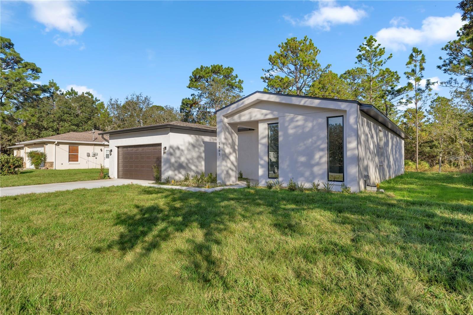 Stunning New Construction –4-Bed,3-Bath Home in Citrus Springs! This exquisite 1,931 sq. ft. brand-new 4-bedroom, 3 bathroom home offers a perfect blend of modern elegance and functional design. The open-concept floor plan is filled with natural light, creating a warm and inviting atmosphere. The gourmet kitchen boasts quartz countertops, sleek ceiling-height white cabinetry, stainless steel appliances, and a spacious island—ideal for both cooking and entertaining. Throughout the home, luxury vinyl plank flooring provides a seamless, low-maintenance look—no carpet anywhere! Expansive double sliding doors lead to a private backyard, offering plenty of space for outdoor relaxation, gatherings, or even future customization. A charming front balcony area adds to the home’s curb appeal, while the double-car garage provides ample storage and parking. Located in the highly desirable Citrus Springs community, this home comes with no HOA restrictions, giving you the freedom to enjoy your property as you see fit. Conveniently situated near local springs, shopping, dining, and outdoor recreation, this is the perfect place to call home. Don’t miss this incredible opportunity—schedule your private tour today!