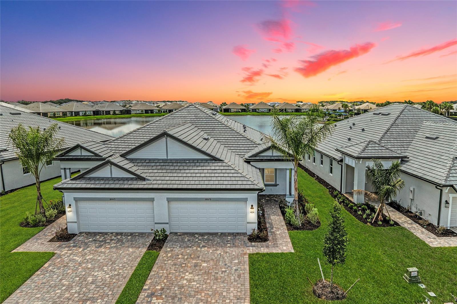 One or more photo(s) has been virtually staged. ***Limited-time special financing available through preferred lender for qualified buyers. Restrictions, terms, and conditions apply. Subject to change without notice.*** Don’t just dream about water view living — make it yours in this beautifully designed spacious almost 1700 square foot Sweetwater villa with breathtaking WATER VIEW and luxury amenities. Experience the perfect blend of style, comfort, and low-maintenance living in this 2-bedroom, 2-bathroom villa with a DEN and 2-car garage. Located in the quiet, gated community of Sweetwater, this home offers a front-row seat to serene lake views and the relaxed Florida lifestyle.
Inside, every detail is thoughtfully chosen — there’s NO CARPET anywhere, only resilient, wood-look LUXURY VINYL PLANK FLOORING in all main living areas and elegant marble-look TILE in the bathrooms and laundry room. IMPACT WINDOWS are installed throughout, so there’s no need for hurricane shutters. The chef-inspired kitchen is as stylish as it is functional, featuring a LARGE CENTER ISLAND, MODERN SOFT CLOSE, GRAY CABINETRY with black hardware, QUARTZ COUNTERTOPS, generous pantry space, and an ABUNDANCE OF CABINETRY offering more storage than you’ll ever need. All appliances shown in the photos are included with the home.
The kitchen flows seamlessly into the dining area and spacious great room, where IMPACT SLIDING GLASS DOORS lead to a COVERED, SCREENED-IN LANAI — the perfect setting for morning coffee or evening cocktails while taking in the west-facing sunset over the water. The private owner’s suite includes a spa-like bathroom with dual sink vanity, QUARTZ COUNTERTOPS, walk-in shower with bench, and an oversized walk-in closet. A separate WATER CLOSET ensures comfort and privacy. A second bedroom and full bath provide comfort for guests, while the DEN offers a flexible space for a home office, media room, or quiet retreat.
As a Sweetwater resident, you’ll enjoy resort-style amenities, including TWO CLUBHOUSES, TWO HEATED POOLS, TWO FITNESS CENTERS, PICKLEBALL COURTS, BOCCE COURTS, BASKETBALL COURT, lots of green space and community event spaces — all in a MAINTENANCE-FREE setting.
Whether you’re entertaining friends, working from home, or simply relaxing by the lake, this villa offers everything you need to live your best Florida life.