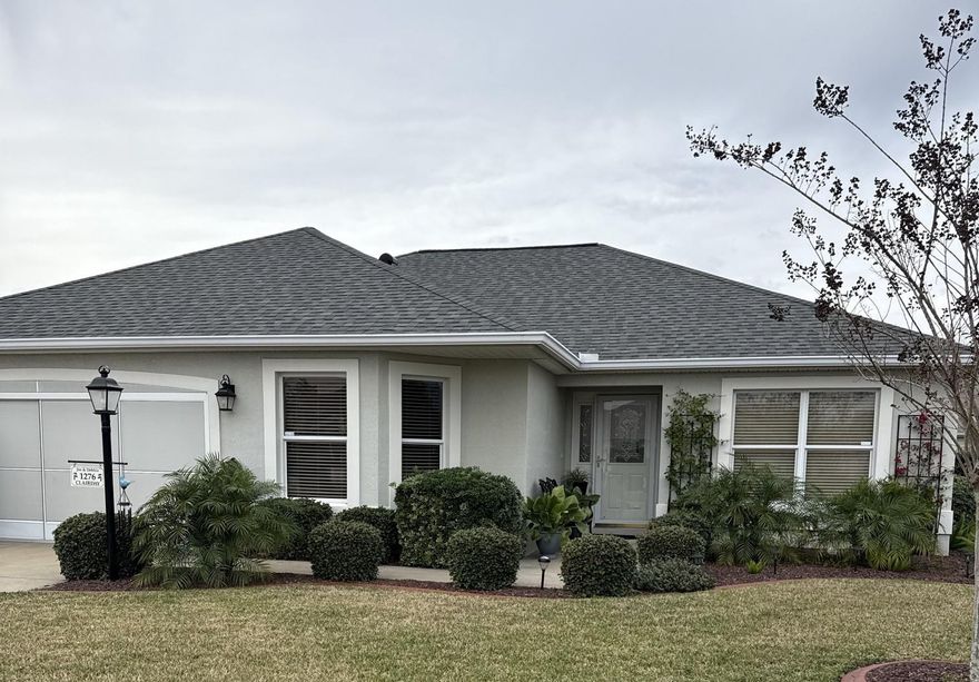 BOND PAID! Furnished Jasmine Designer home in The Villages! This well-maintained block and stucco home features 3 bedrooms, 2 full baths, and a 2-car garage, ideally located in the highly desirable Village of Glenbrook. Enjoy convenient access to the Polo Grounds, Glenview Country Club, shopping, dining, banks, and multiple recreation centers. Recent updates include a newer roof (2019), HVAC system (2020), gutters, and mature landscaping. Additional features include leaded glass front door with side panel, privacy screen on the garage door, whole-house water filtration system, and ADT security system. The interior offers a spacious eat-in kitchen with abundant cabinetry, quartz countertops, refrigerator, gas range, and pass-through to the dining area. The open dining and living room combination boasts volume ceilings, recessed lighting, and new luxury vinyl plank flooring throughout (no carpet). The primary suite includes a walk-in closet and private bath, with an inside laundry conveniently located off the master bathroom. Relax year-round in the enclosed lanai featuring sliding doors, an electrical retractable awning, and a separate Mitsubishi heating and cooling system—perfect for entertaining or quiet enjoyment. Truly move-in ready — schedule your private showing today! Room Measurements and Square Footage are approximate and should be verified by buyer/buyer’s agent. All information is deemed reliable but not guaranteed.