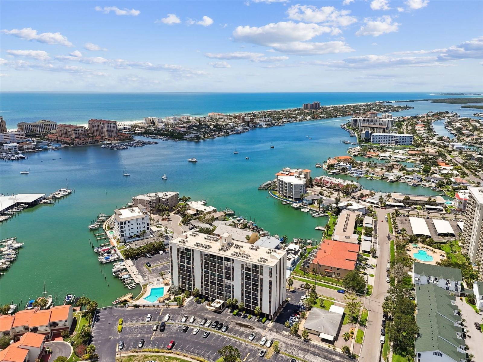Just moments from the sugar-white sands of Clearwater Beach, Unit 207 at Dolphin Cove offers the perfect blend of laid-back beach style living and everyday convenience. Imagine waking up and being only a short stroll or bike ride away from one of America’s top-rated beaches, where turquoise waters and stunning sunsets await you daily. This beautifully upgraded 1-bedroom, 1-bath 765 sq. ft. condo features a bright, open floor plan with sliding glass doors that fill the space with an abundance of natural light. The condo boasts modern updates throughout the entire unit with tasteful finishes that flows seamlessly with the open floor plan in the dining and living areas—perfect for entertaining or unwinding after a beautiful beach day. Condo has a new AC unit in the summer of 2025. Enjoy resort-style amenities, including a waterfront oversized heated pool, community dock for fishing, covered bike parking area, easy access to plenty of dining, shopping and entertainment near the Clearwater Aquarium with vibrant nightlife—all within walking distance. The clubhouse is available to all residents and can be reserved for private parties with a kitchen and opens onto the pool deck. Whether you’re looking for a year-round residence, a vacation home, or an investment property, this is a rare opportunity to own a slice of paradise just steps from the beach. Don't miss out on this prime Clearwater Beach location—where every day feels like a vacation!