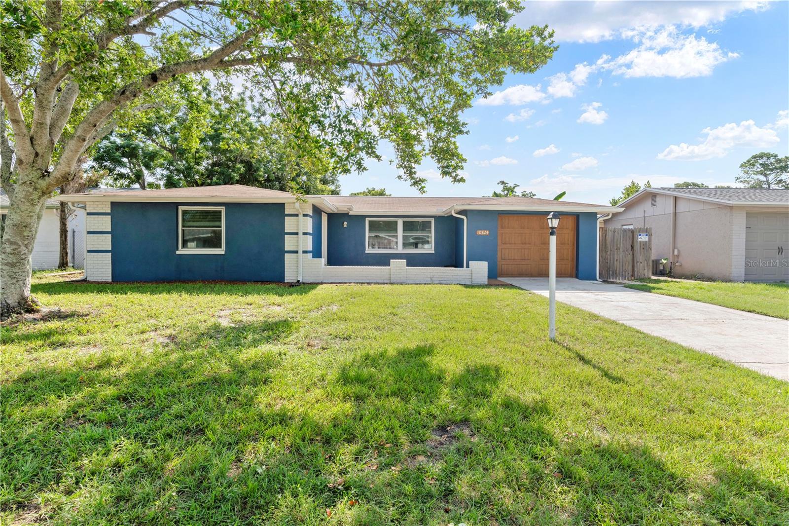 Welcome to your BEAUTIFULLY REMODELED 3-bedroom, 2-bathroom home, where comfort, style, and functionality come together in perfect harmony. Whether you're looking for a sunny Florida retreat or a full-time residence, this move-in ready gem is the perfect place to call home. Inside, you’ll find a spacious open floor plan with new luxury vinyl plank flooring throughout, creating a bright and seamless flow from room to room. The kitchen is a true highlight, featuring freshly painted cabinets, gorgeous stone countertops, a pot filler over the stove, a vent hood, and UPDATED LG APPLIANCES (2020)—with a dedicated space for a beverage cooler. It’s ideal for both everyday living and entertaining guests. The primary suite offers a peaceful retreat with two walk-in closets, a dual sink vanity, a walk-in tiled shower, and an extra bonus space that can be used as a cozy reading nook, home office, or dressing area. Step outside to your private fenced-in backyard, where a sparkling ABOVE-GROUND POOL with a composite deck and BRAND-NEW LINER awaits—perfect for soaking up the sunshine and making memories with friends and family. This home has been thoughtfully updated with NEW ELECTRICAL AND PLUMBING SYSTEMS (2021), IMPACT WINDOWS in the front (2018), DOUBLE-PANE WINDOWS throughout the rest of the home (2020), and a NEW WATER HEATER (2025). Additional features include a WiFi security system, INDOOR LAUNDRY room with built-in washer and dryer pedestal, and pre-cut plywood hurricane shutters for peace of mind during storm season. From the charming curb appeal to the modern upgrades inside, this home is truly ready for you to move in and start living your Florida dream!
