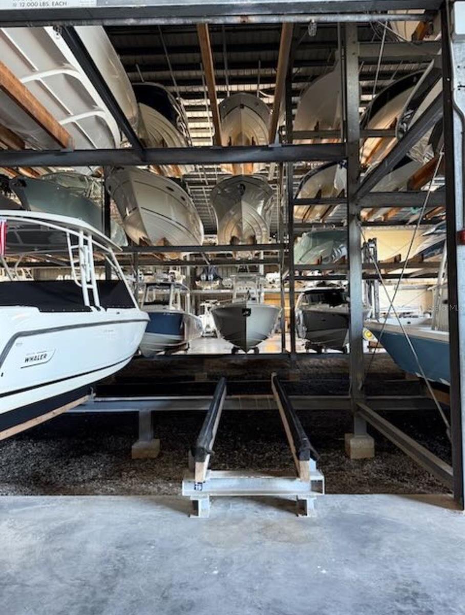 Highly desirable floor-level T-Top boat rack at Osprey Harbor Village with 12 ft of height! This XL rack accommodates vessels up to 30.5L x 10W x 12H and offers quick access to Midnight Pass and Venice Inlet. Marina amenities include call-ahead splash, fuel, ice, bait and tackle, fish cleaning station, adjacent restaurant, maintenance racks, and wash-down service after each use. Monthly condo fees of $424 cover insurance, marina and building maintenance, staff, and equipment. Indoor storage reduces insurance costs, and racks may be rented, making this a great investment in Sarasota waterfront property. When you own indoor boat storage, you'll have year-round peace of mind with protection from the elements.