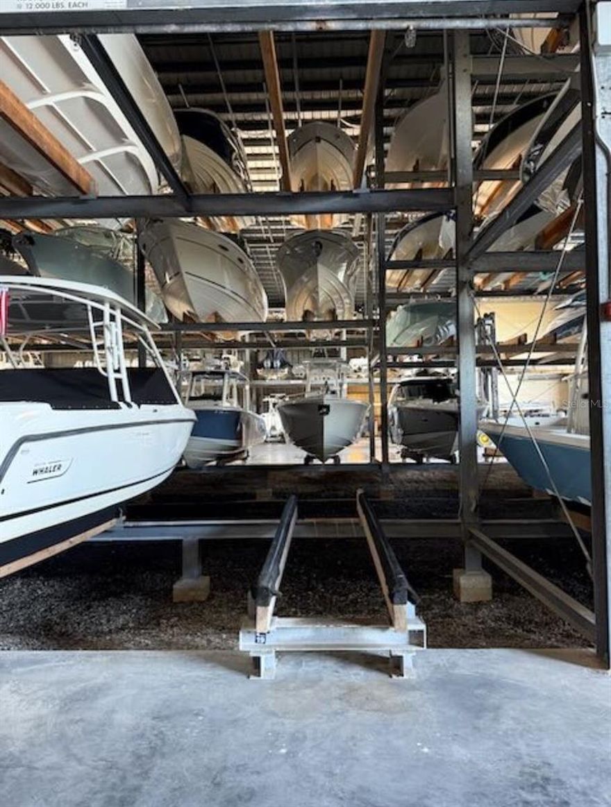 Highly desirable floor-level T-Top boat rack at Osprey Harbor Village with 12 ft of height! This XL rack accommodates vessels up to 30.5L x 10W x 12H and offers quick access to Midnight Pass and Venice Inlet. Marina amenities include call-ahead splash, fuel, ice, bait and tackle, fish cleaning station, adjacent restaurant, maintenance racks, and wash-down service after each use. Monthly condo fees of $424 cover insurance, marina and building maintenance, staff, and equipment. Indoor storage reduces insurance costs, and racks may be rented, making this a great investment in Sarasota waterfront property. When you own indoor boat storage, you'll have year-round peace of mind with protection from the elements.