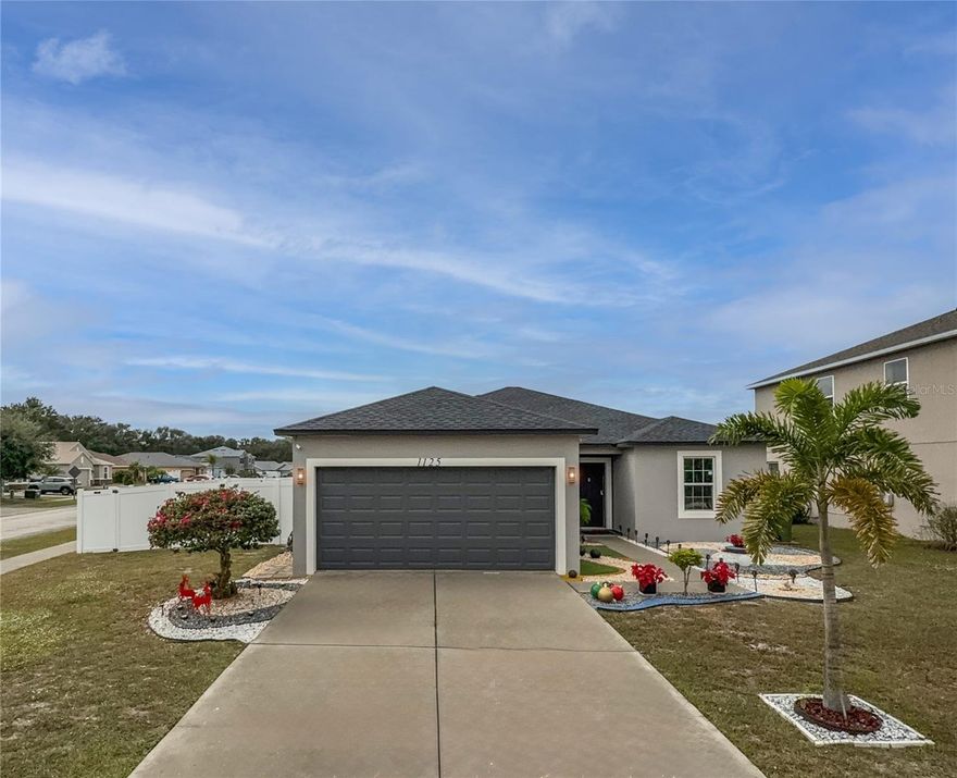 Welcome home to this beautifully renovated 3-bedroom, 2-bath property with a 2-car garage, perfectly situated on a spacious corner lot in the welcoming Brenton Manor community in Winter Haven. Surrounded by peaceful natural lakes and friendly neighborhood streets, this move-in-ready home offers the ideal setting for your first step into homeownership.  Inside, you are greeted by a versatile front room that can easily become your home office, a cozy family space, or a formal dining area—whatever fits your needs. The bright, modern kitchen features white cabinetry, quartz countertops, a stylish backsplash, and a comfortable breakfast nook where you can enjoy your morning coffee. The kitchen opens directly into the main living area, creating a natural flow for everyday living and hosting friends and family.  The private primary suite gives you a comfortable retreat with a beautifully updated bathroom and a walk-in closet for convenient storage. With a split floor plan, the two additional bedrooms and second bathroom are tucked away on the opposite side of the home—perfect for children, guests, or a roommate.  You’ll appreciate the easy-care luxury vinyl plank flooring throughout, the dedicated laundry room located just off the kitchen, and the attached garage for added convenience.  Step outside through the sliding doors to a brand-new screened and covered porch overlooking a fully fenced backyard—ideal for pets, weekend barbecues, or simply relaxing after a long day.  This home also includes energy-efficient solar panels with a low monthly payment, helping keep utility costs down, along with a low HOA for even more affordability—key advantages for first-time buyers looking to build stability and equity.  If you’re ready for a fresh start in a beautifully updated home with modern finishes and smart savings, this one is a must-see. Schedule your private tour today and take the next step toward homeownership.